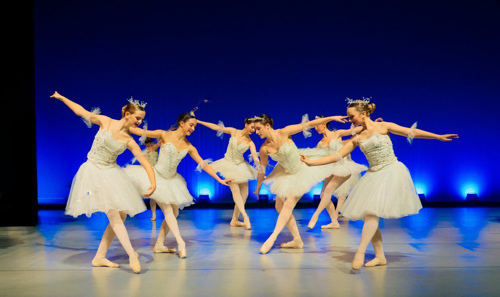 Young ballet dancers perform holiday-themed ballet on stage