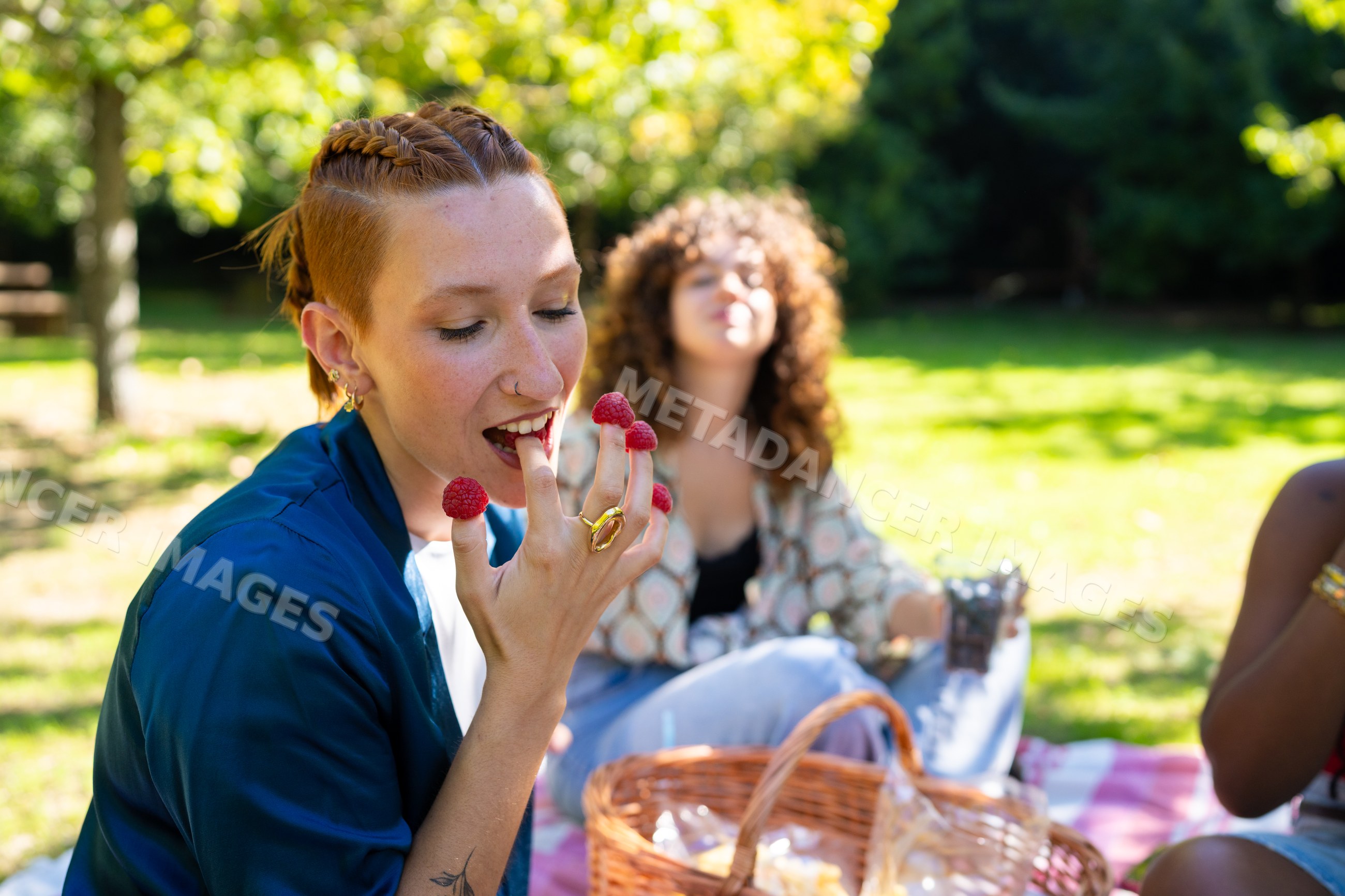 White and African American woman eating raspberries