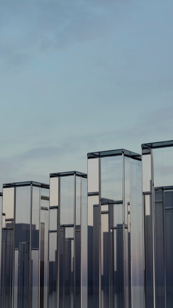 Transparent glass pillars reflecting city skyline