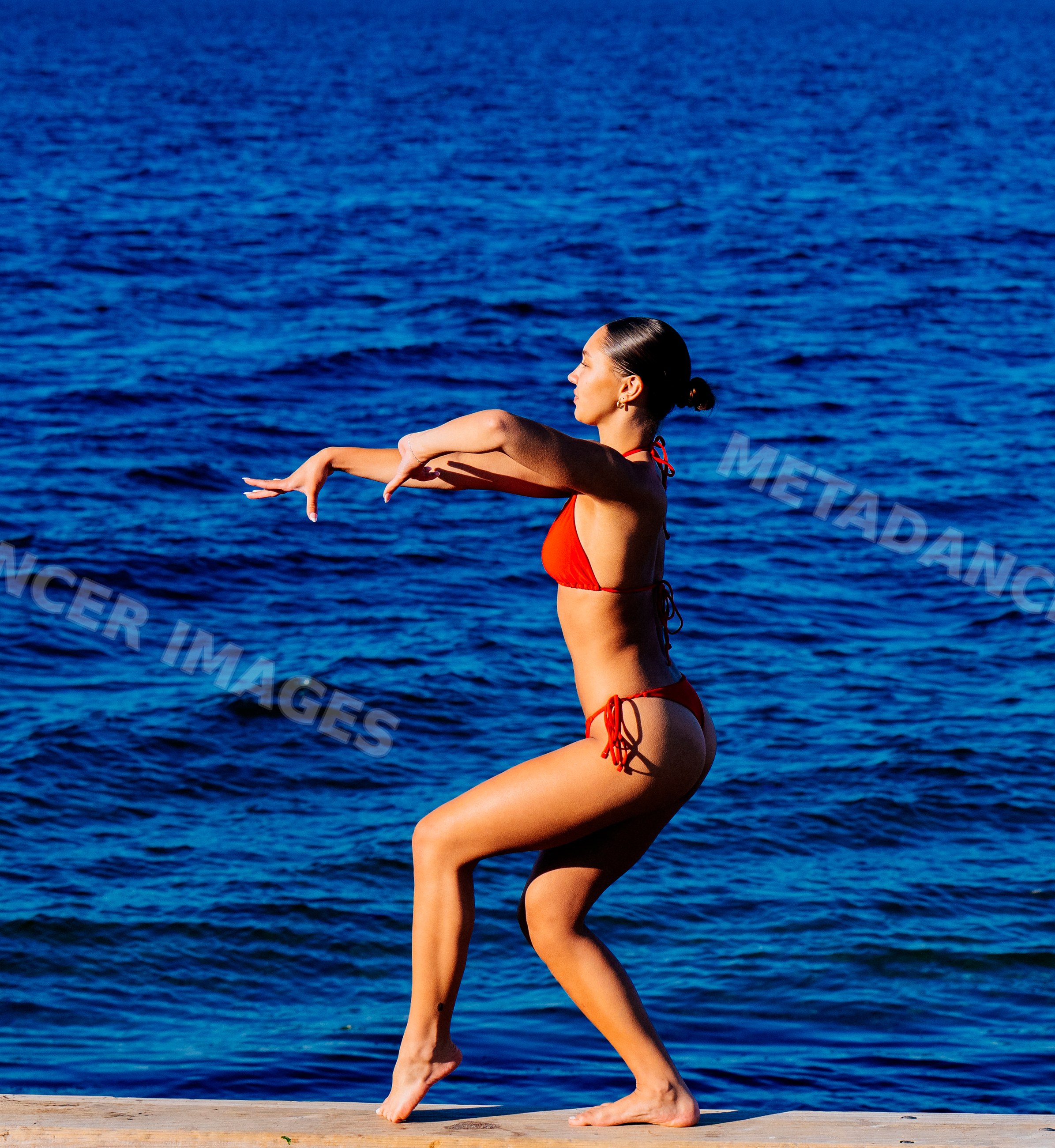 Young woman in swimwear standing near the ocean in wa USA