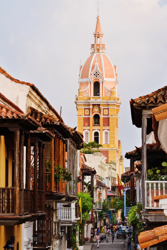 Street scene with colorful cathedral tower and wooden balconies