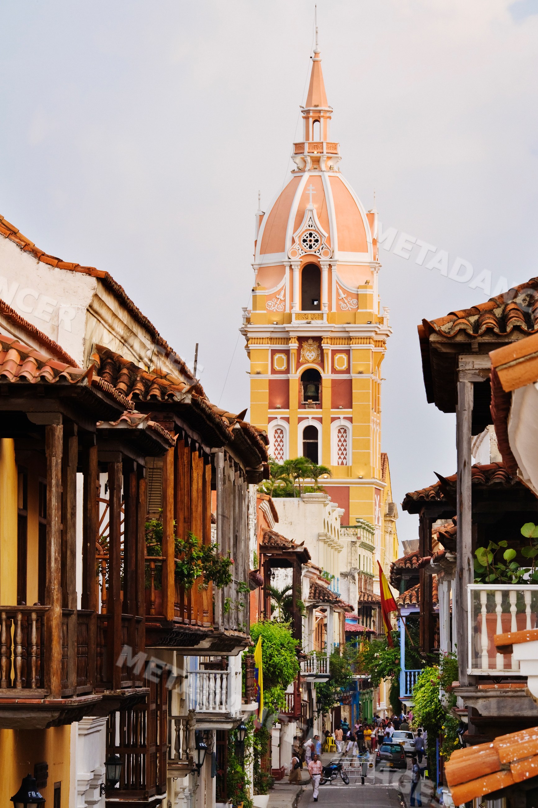 Street scene with colorful cathedral tower and wooden balconies