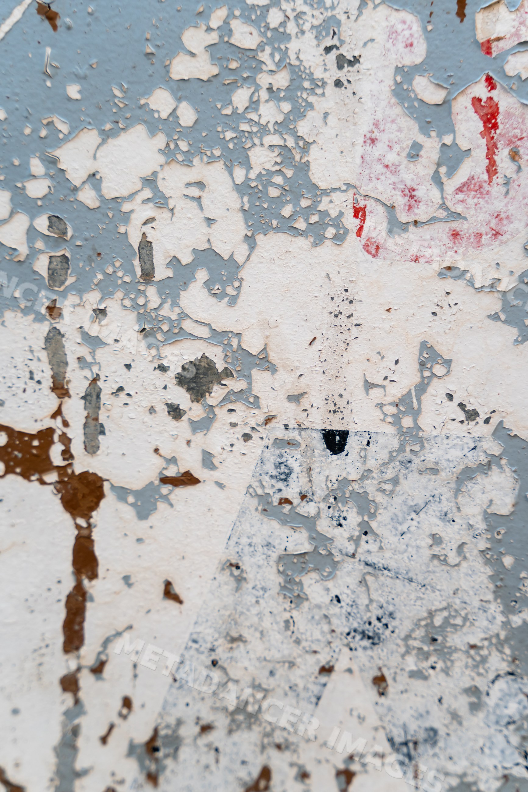 Peeling paint texture on a weathered multicolored wall surface