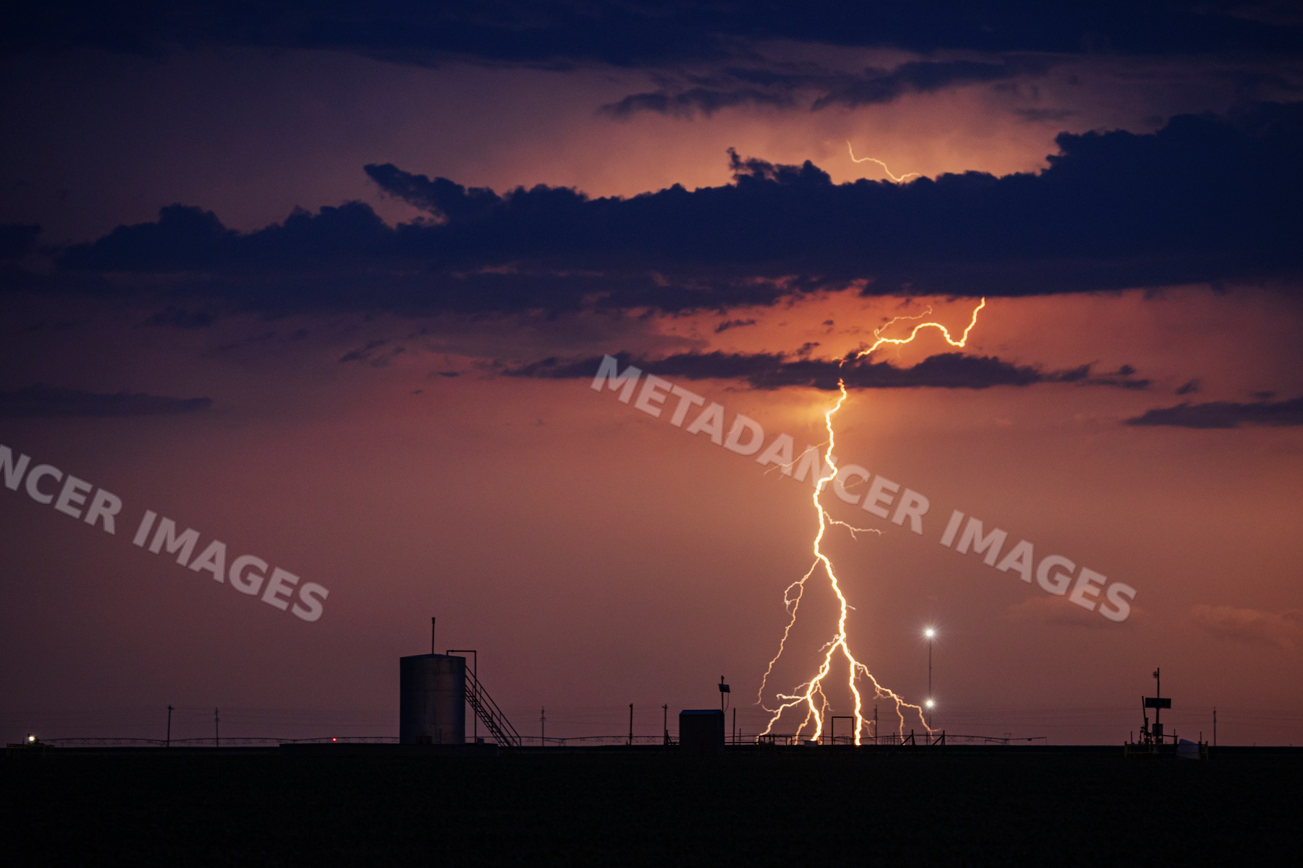 Lightning striking over storm clouds in perryton, texas at night