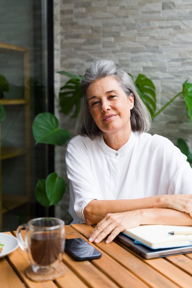 Middle-aged white woman sitting relaxed