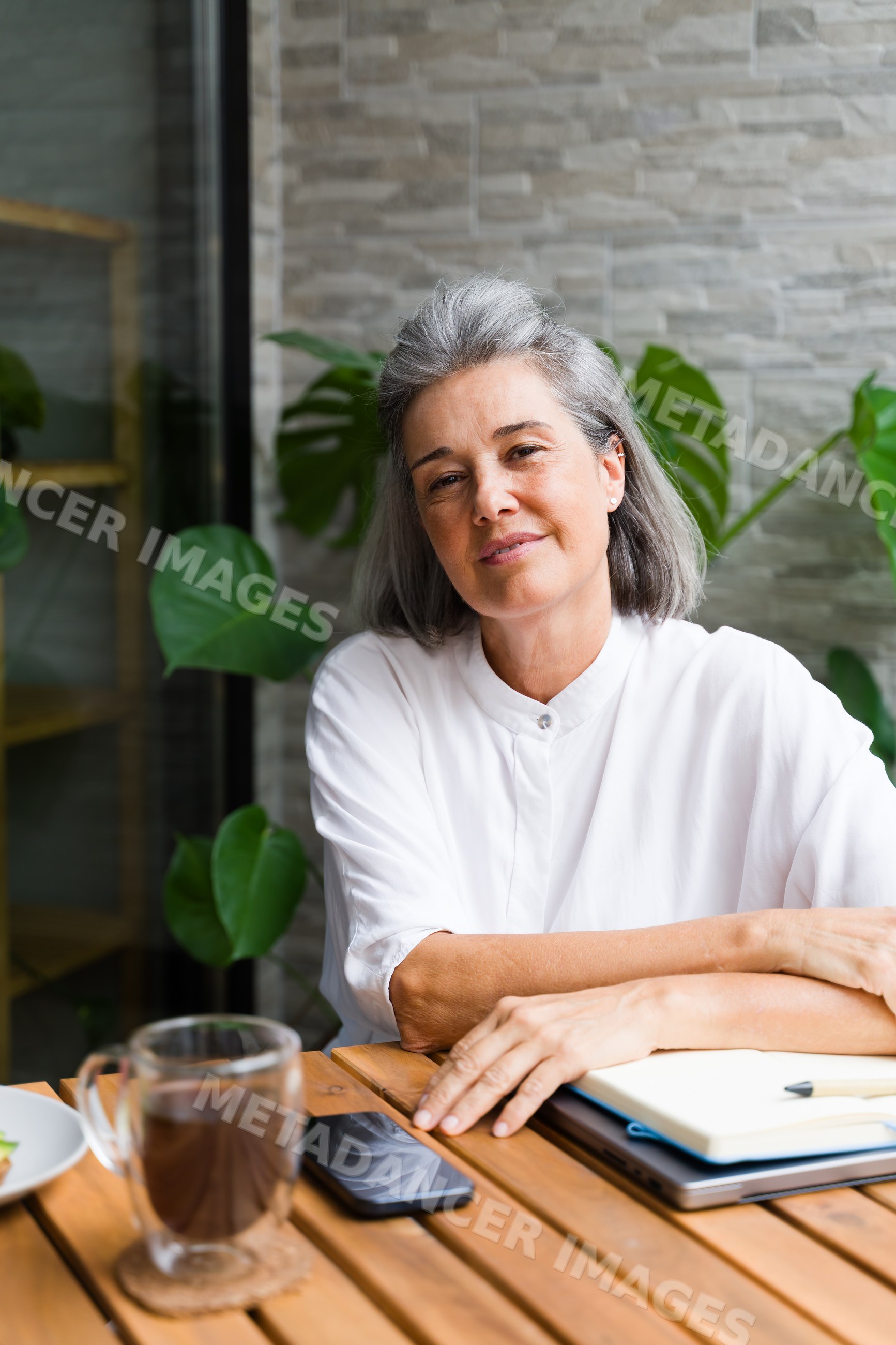 Middle-aged white woman sitting relaxed