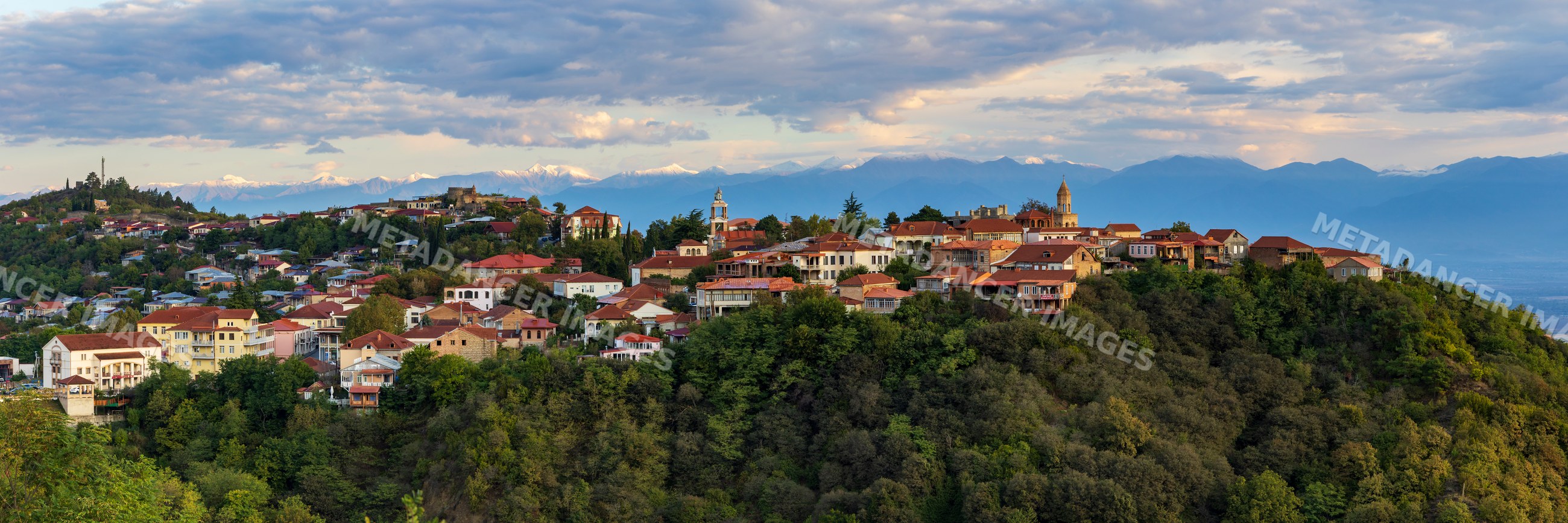 Town of Sighnaghi on hillside with Caucasus Mountains
