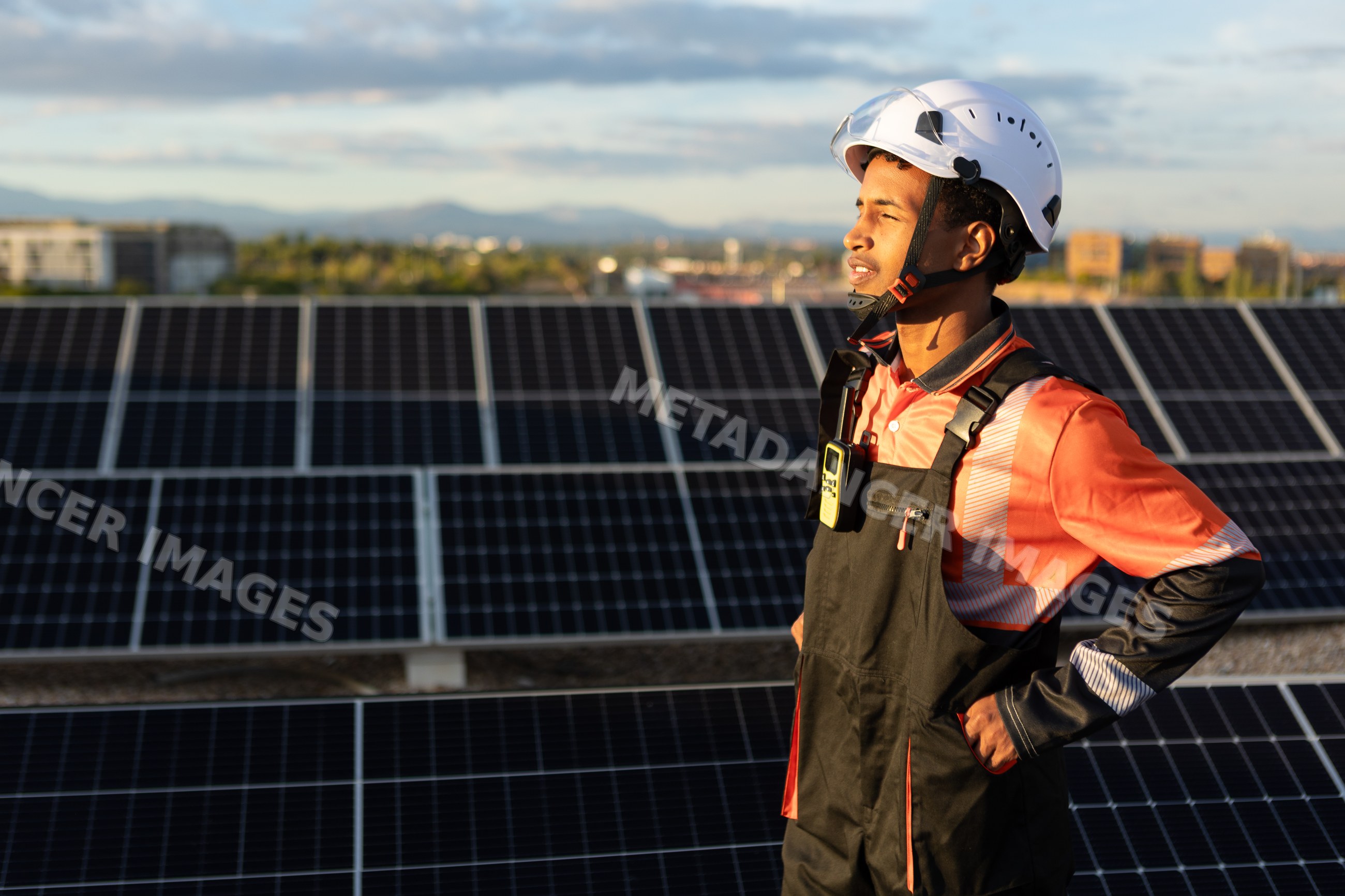 Solar energy technician working amidst solar panels