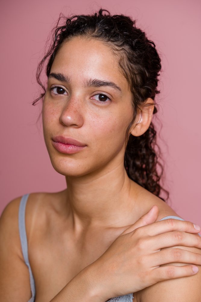 Portrait of Hispanic woman with natural skin and curly hair