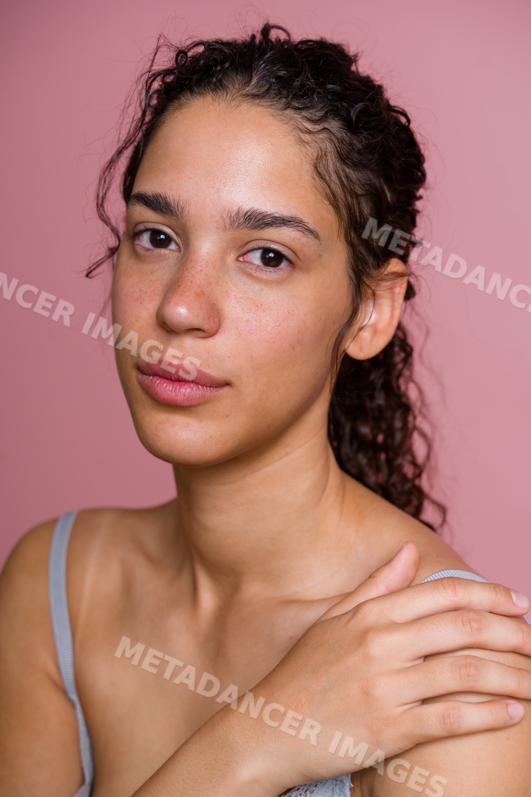 Portrait of Hispanic woman with natural skin and curly hair