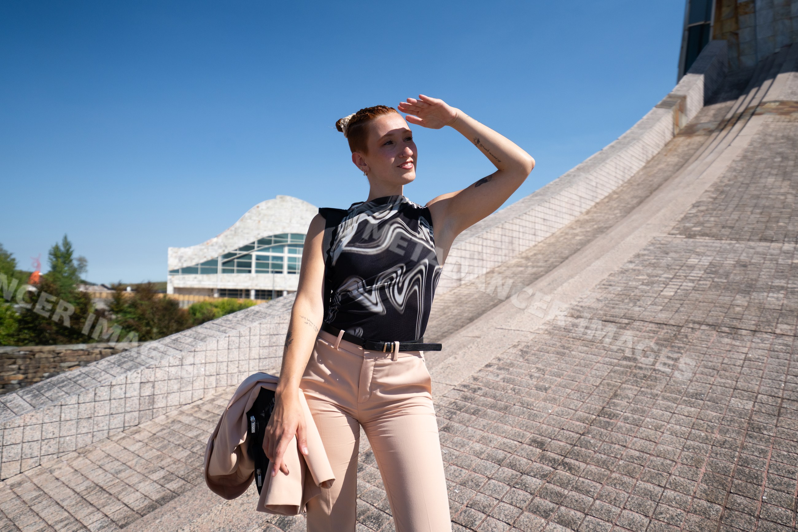 Businesswoman posing outdoors near modern urban architecture