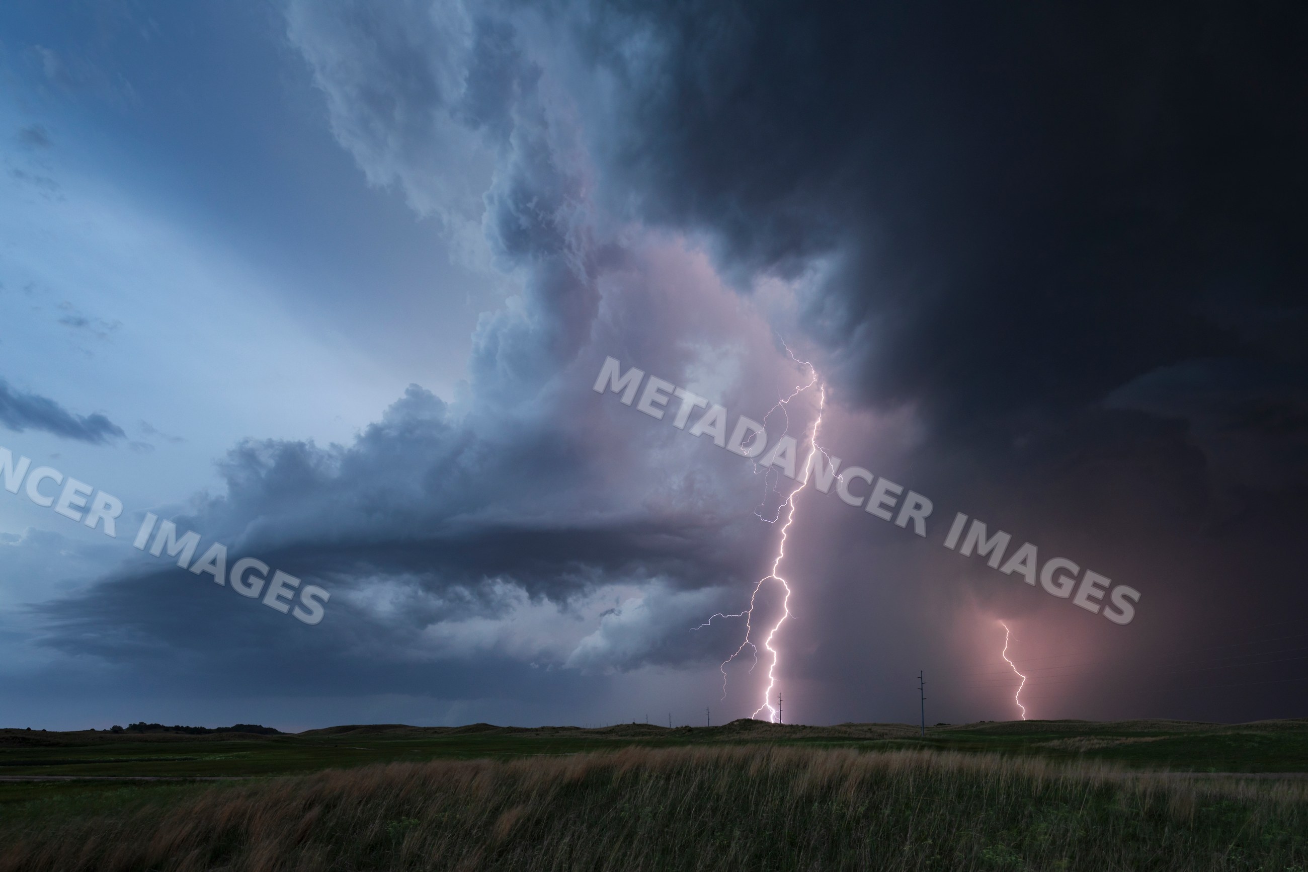 Lightning Strike illuminates storm clouds over nebraska sandhills