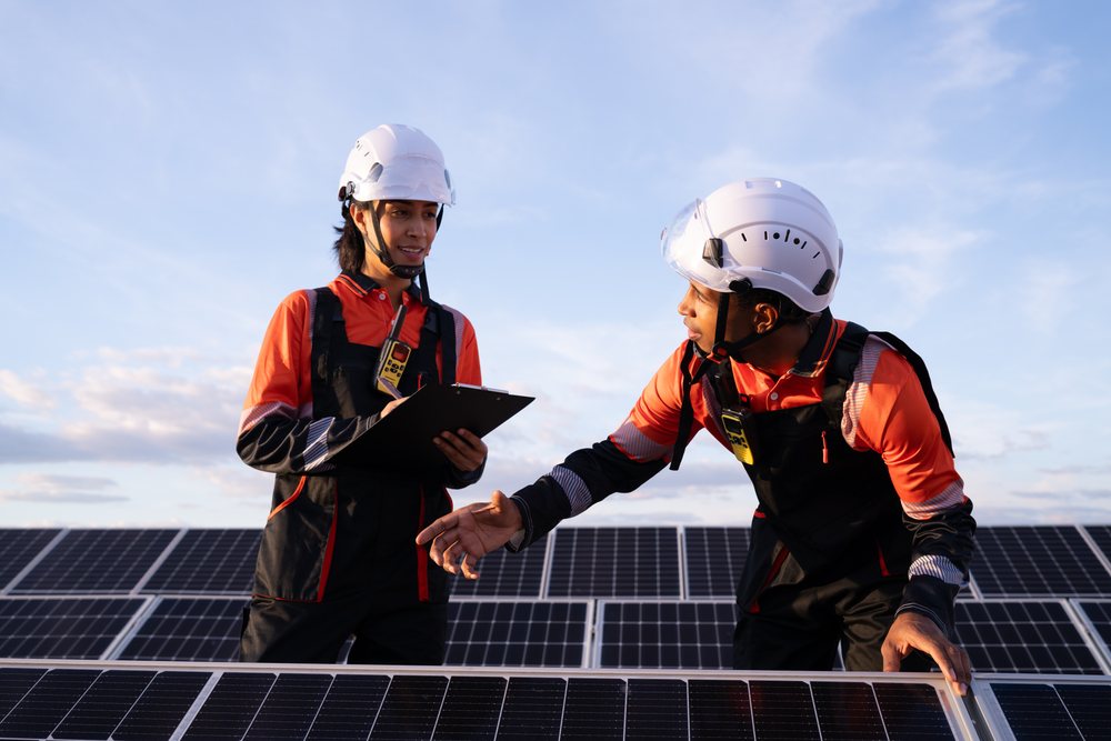 Engineers inspecting solar panels in renewable energy field in Madrid