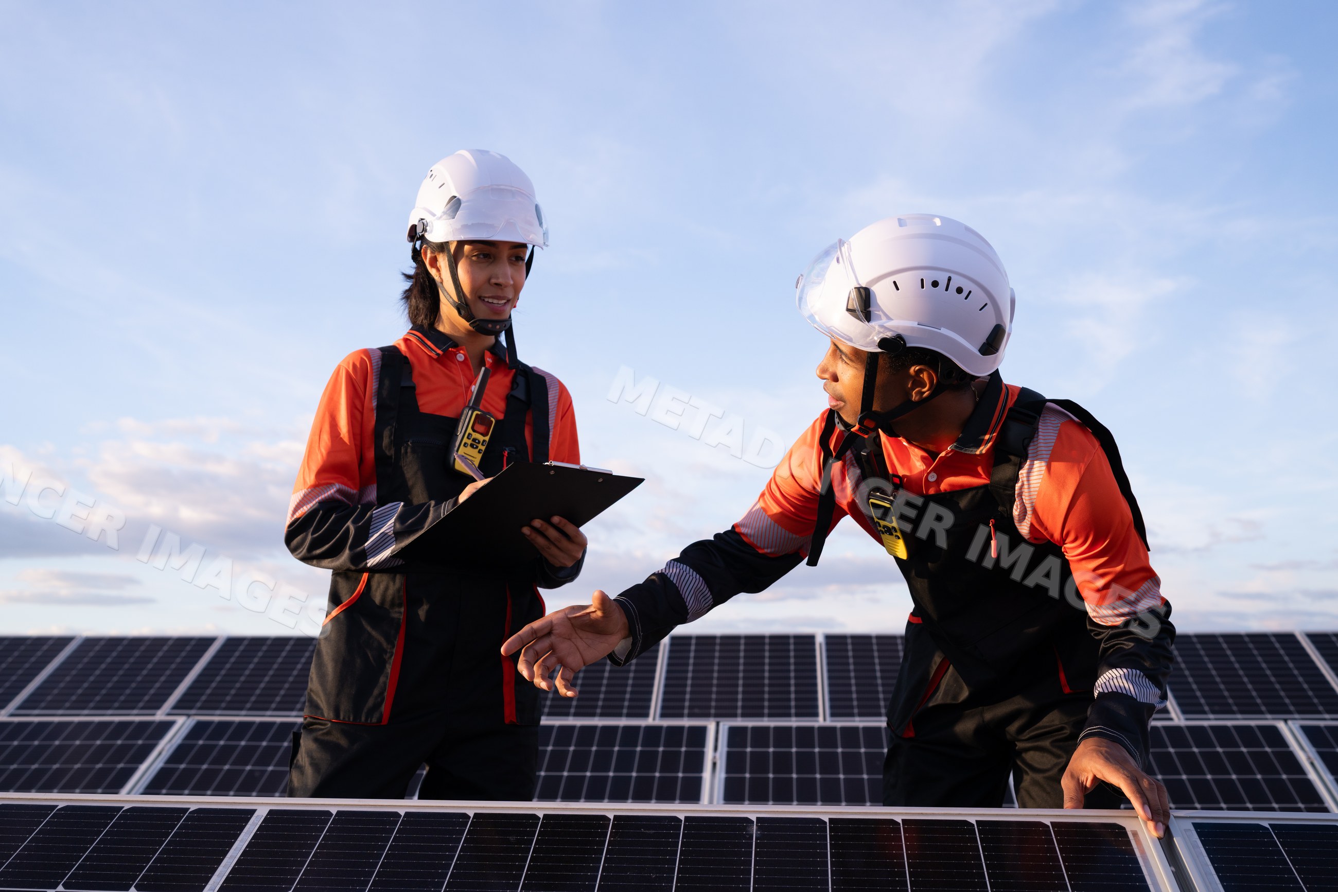 Engineers inspecting solar panels in renewable energy field in Madrid