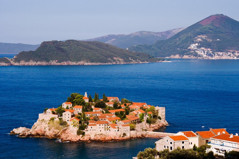 Sveti stefan island with red tile roof stone village
