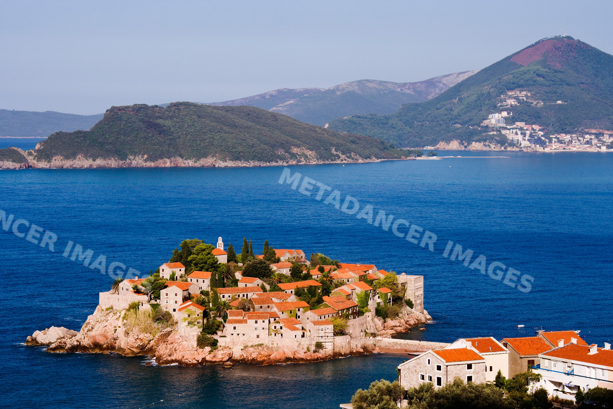 Sveti stefan island with red tile roof stone village