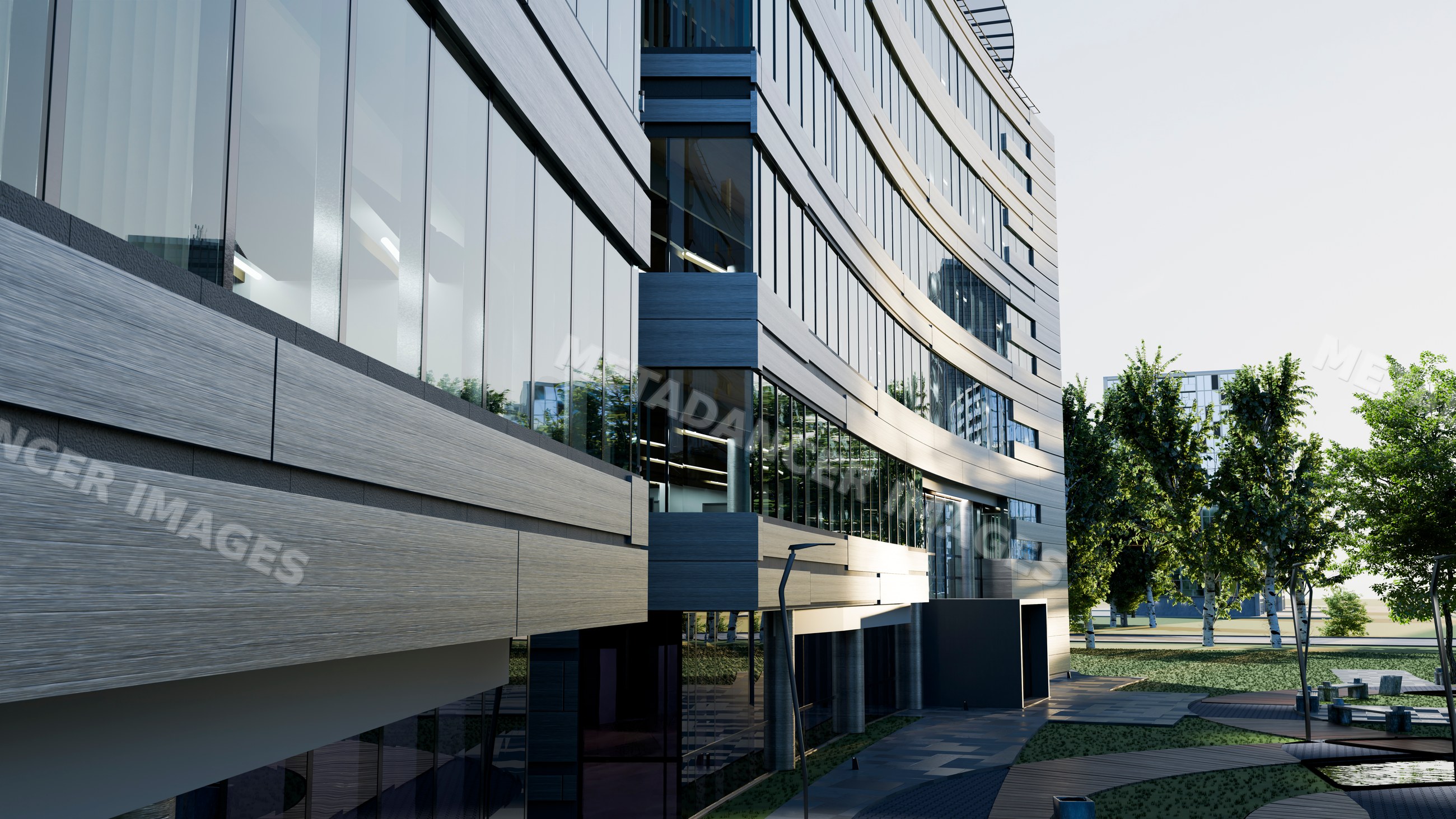 Modern office building with curved glass facade and outdoor greenery