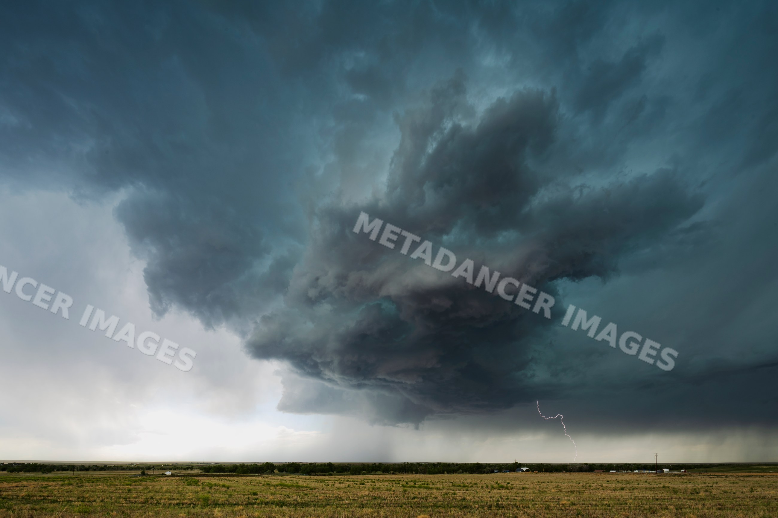 Supercell storm with lightning over rural field in byers, colorado