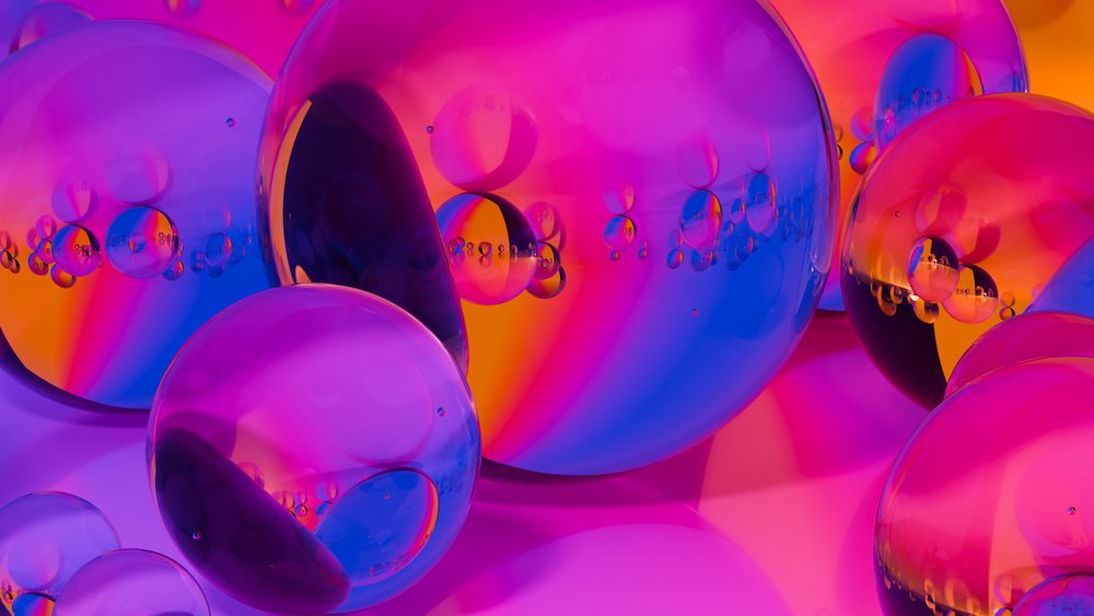 Colorful transparent bubbles clustered on vibrant gradient background