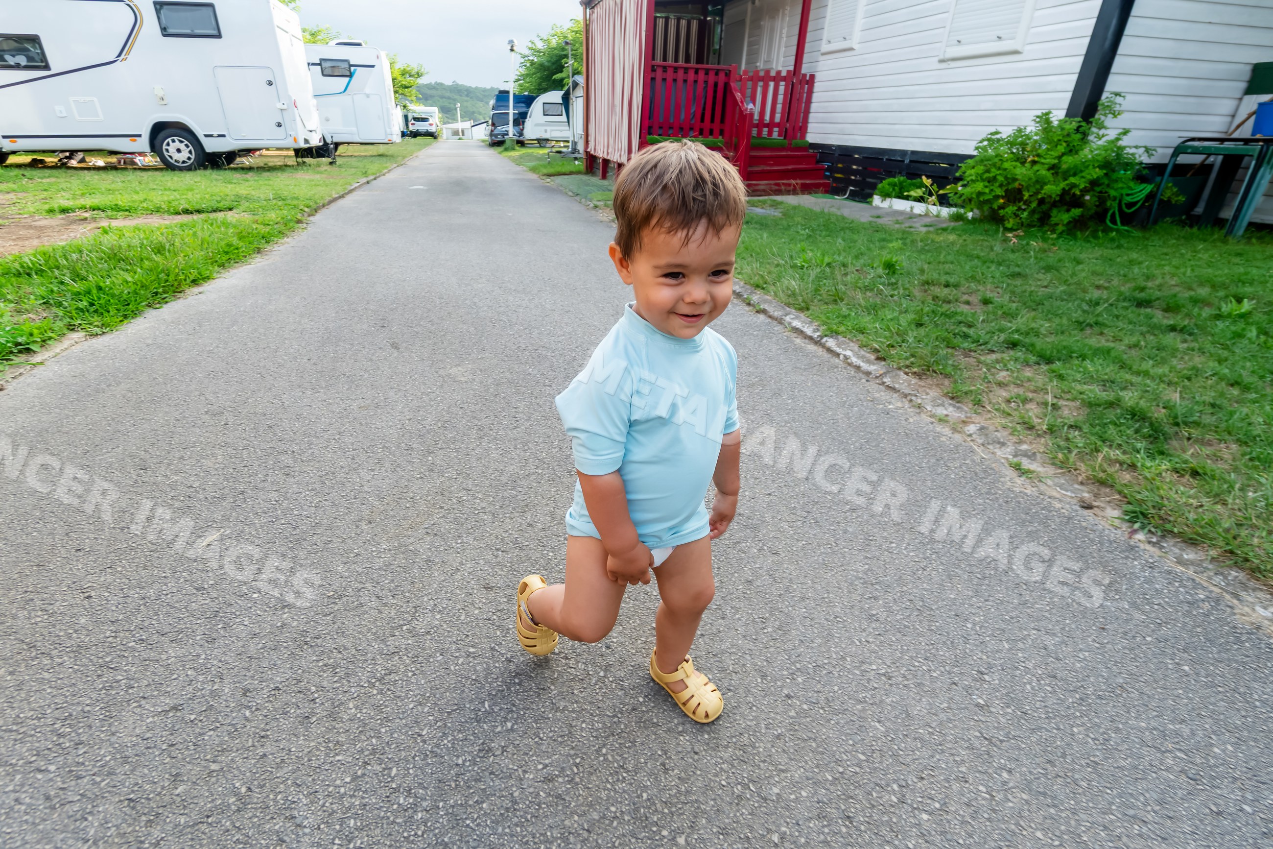 Toddler walking near camping trailers outdoors
