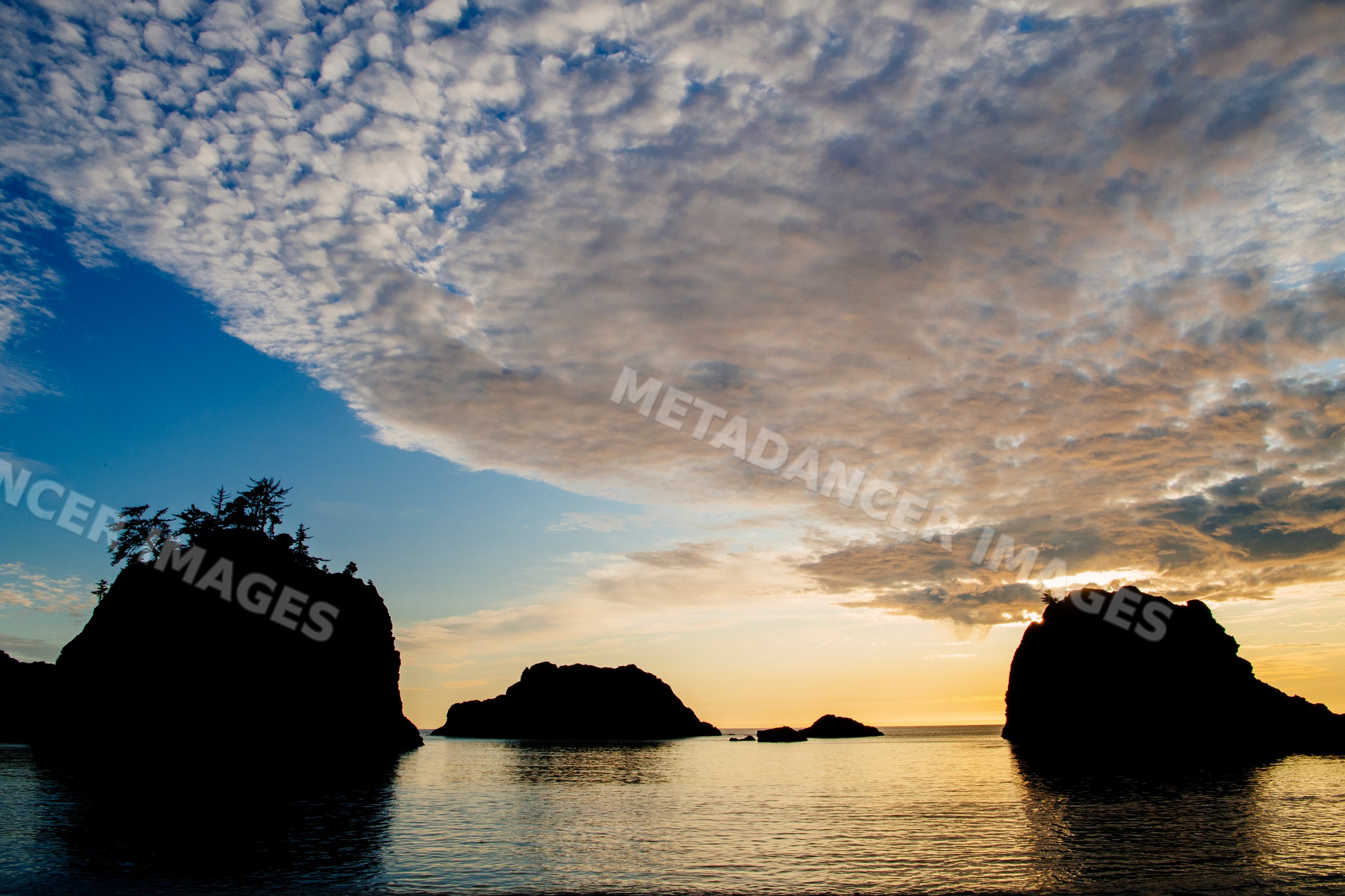Sunset over ocean rock formations