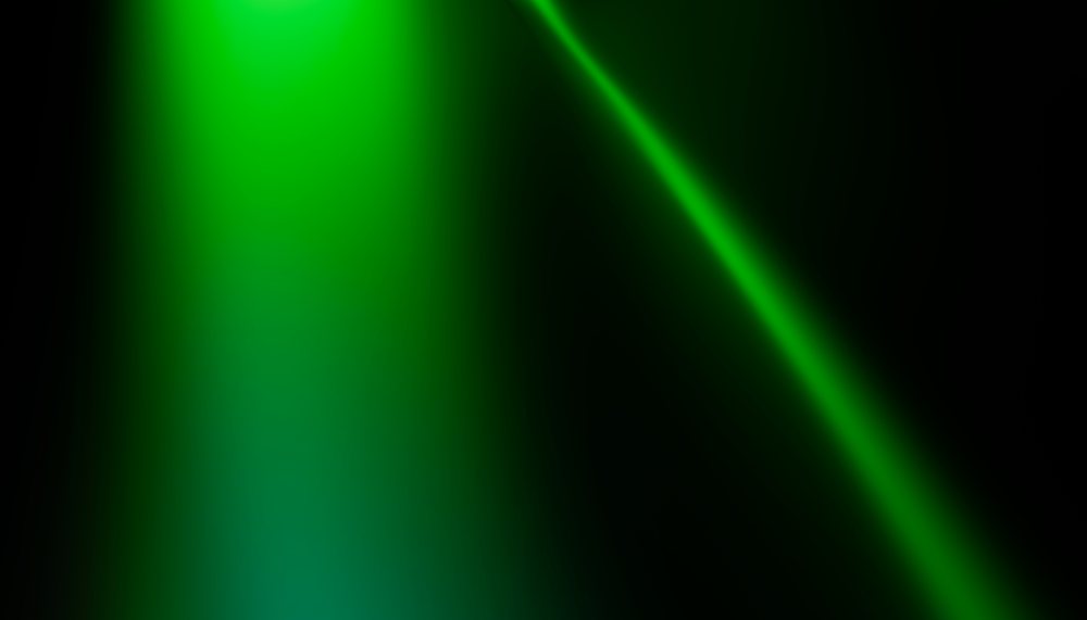 Green glowing curved light on dark background with abstract gradient