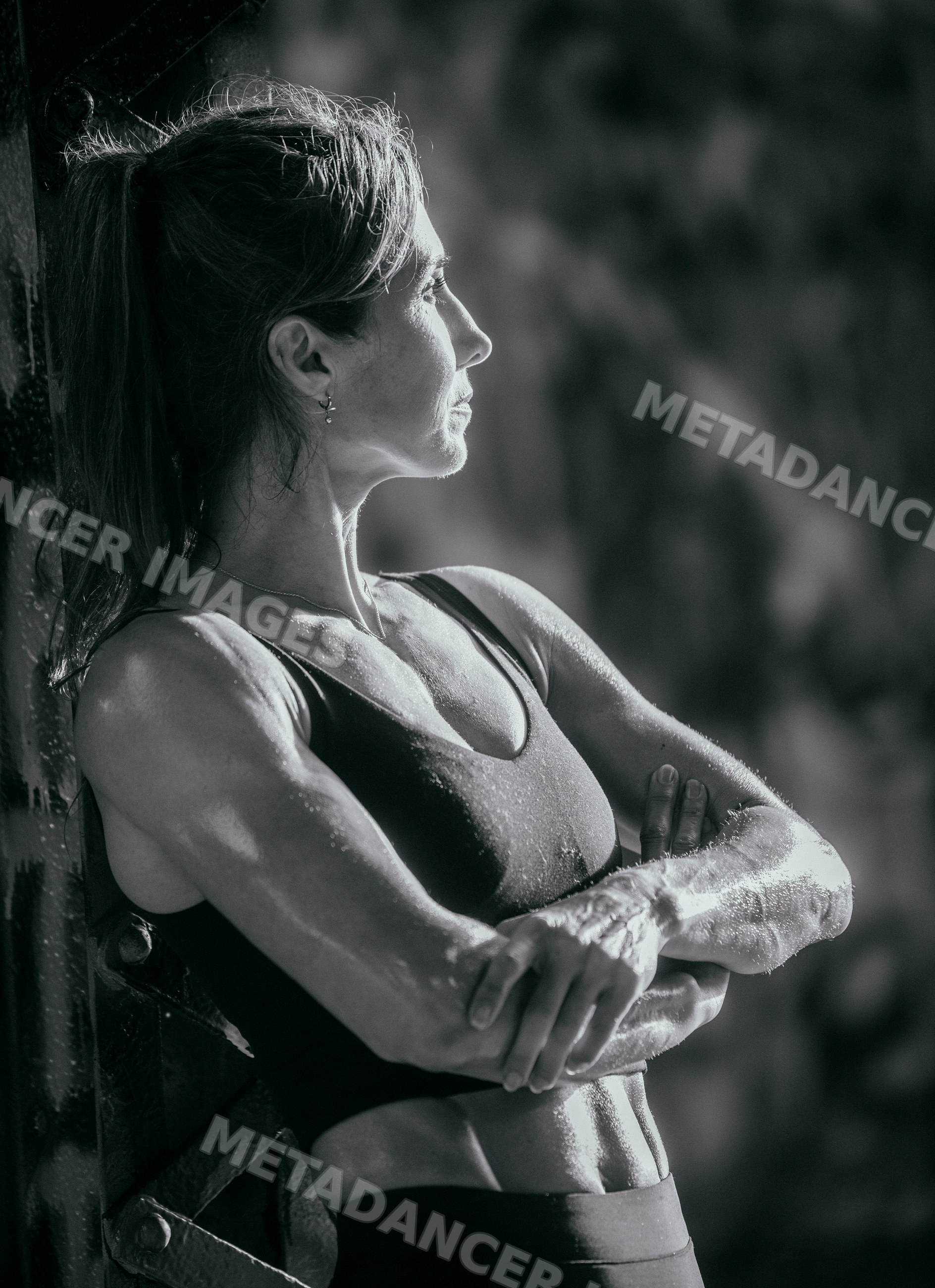 Muscular white woman in tank top during outdoor calisthenics workout