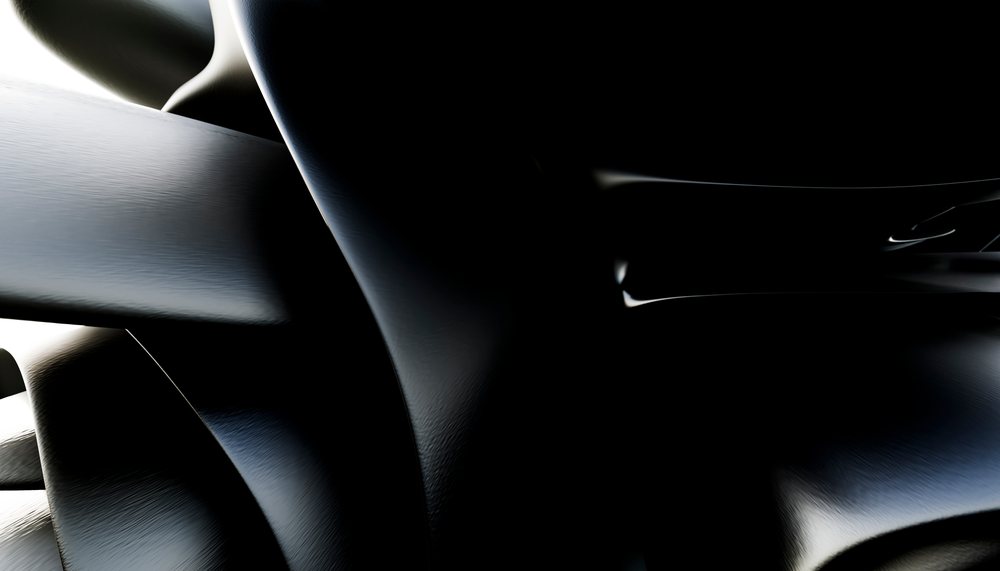 Close-up abstract shiny black curved surfaces with smooth texture