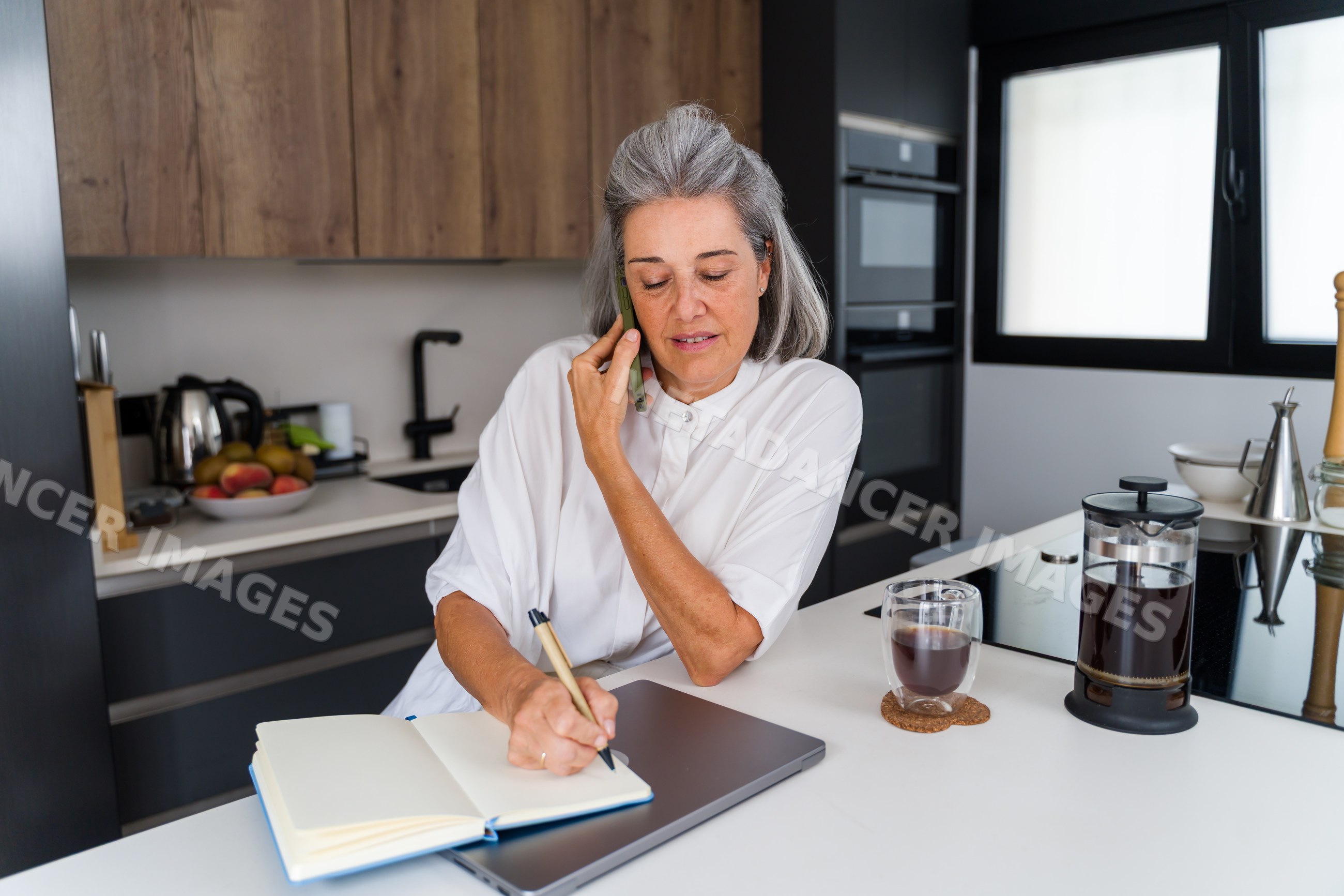 Mature white woman writing in notebook