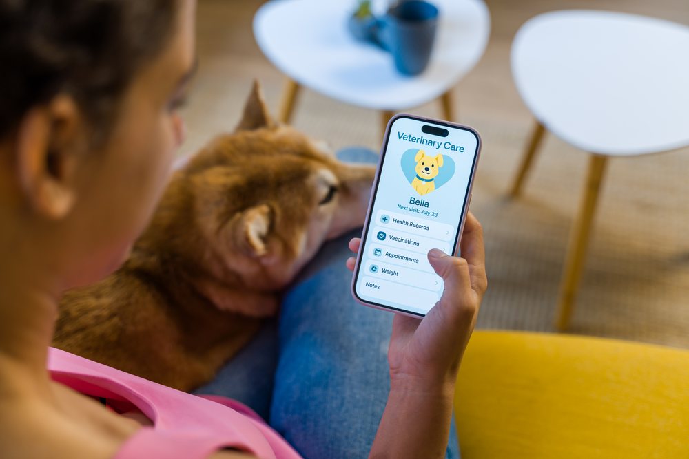 Hispanic Person using an animal health app to manage dog health