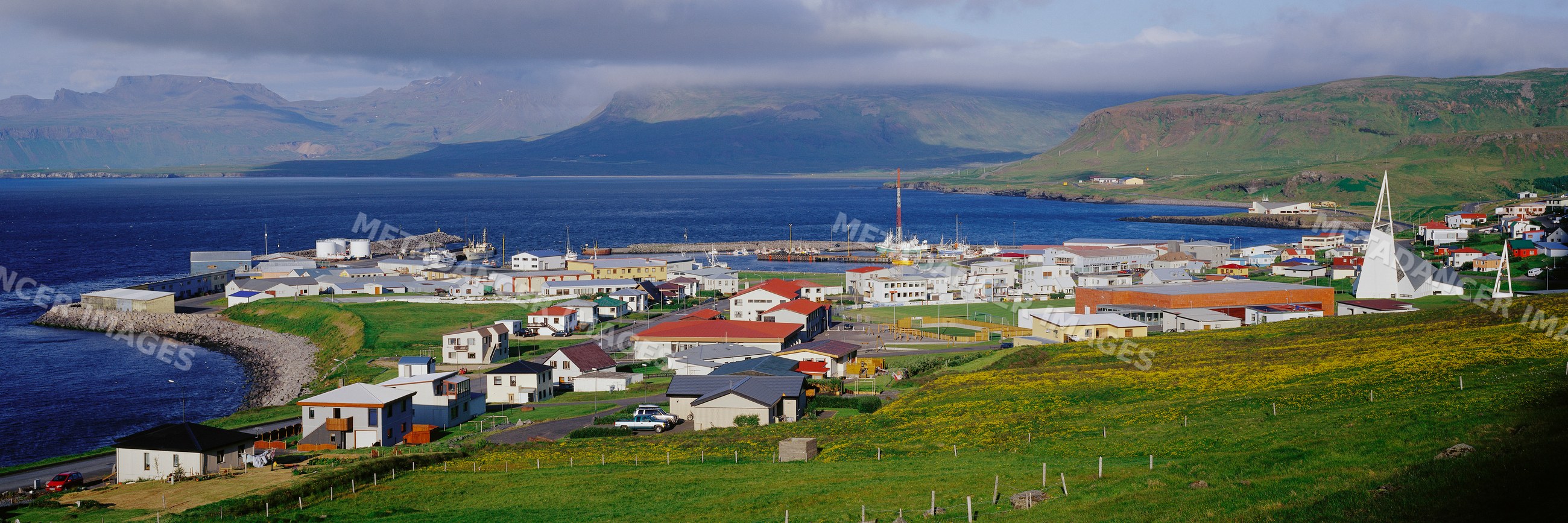 Coastal town with harbor and mountains