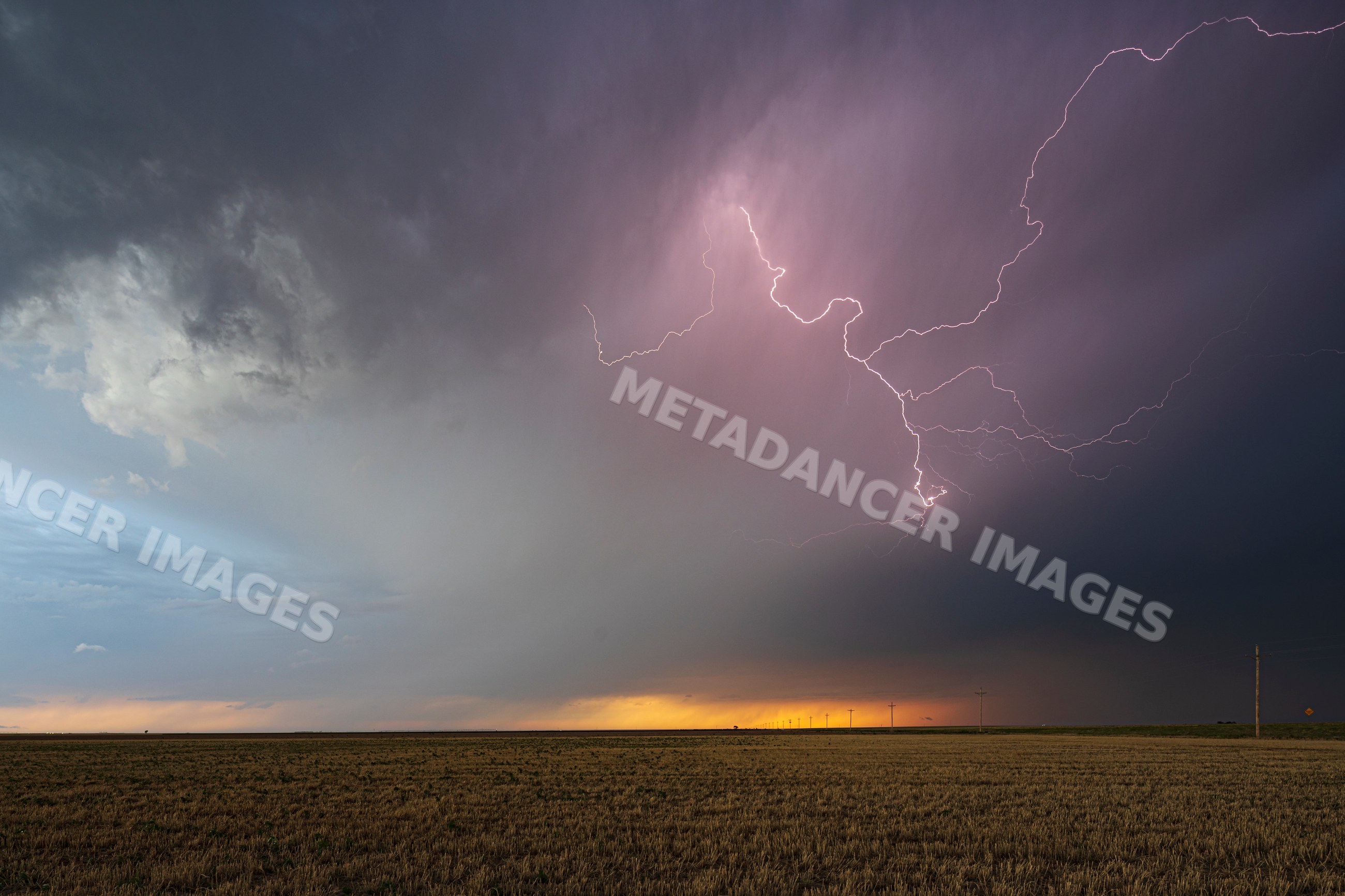 Lightning striking during Storm over rural field in ulysses, kansas