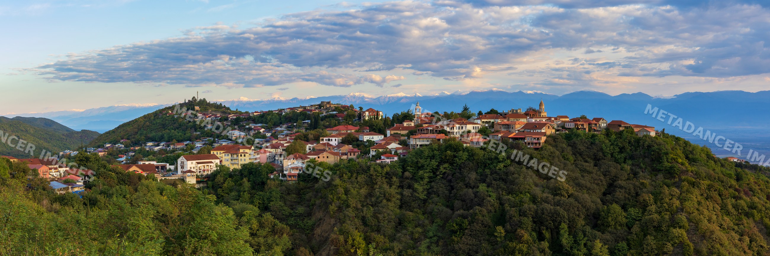 Sighnaghi town on hillside with Caucasus Mountains