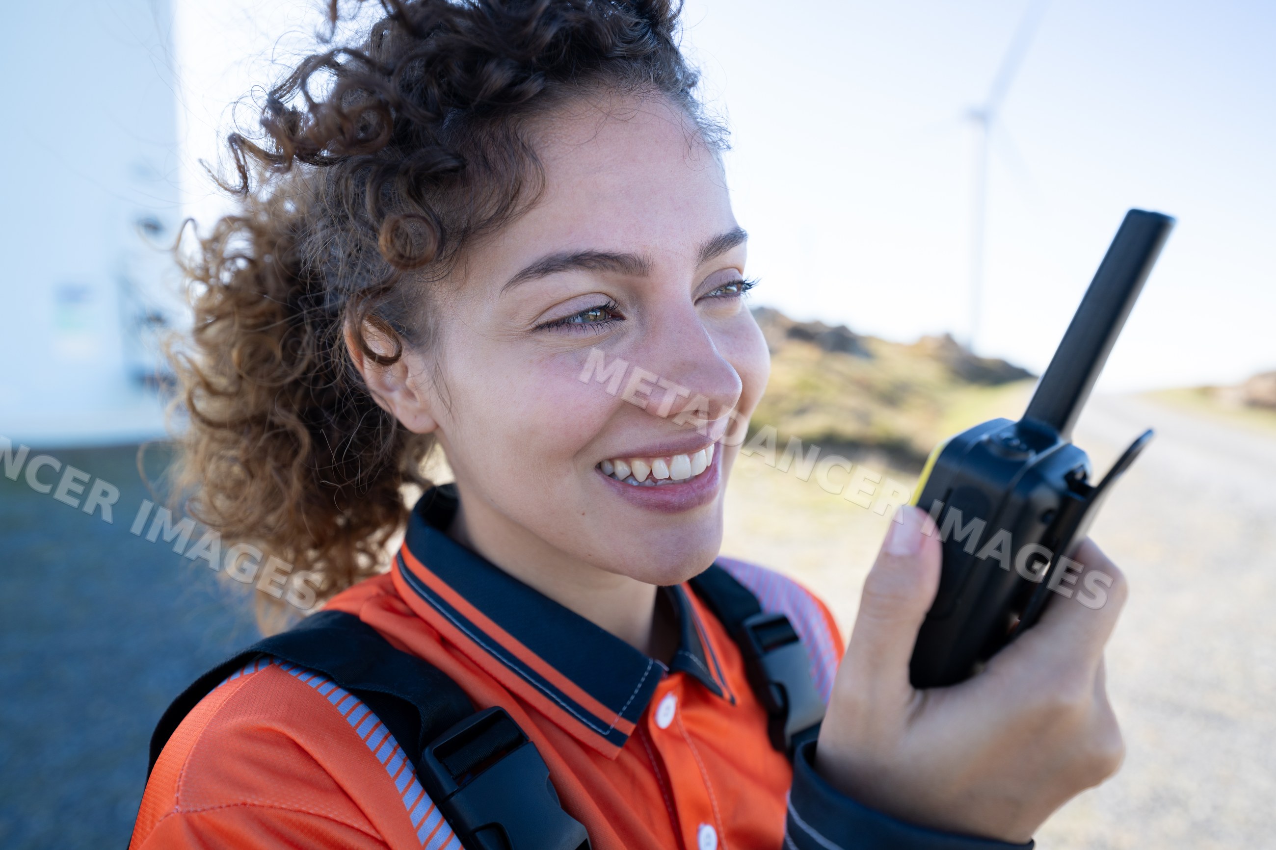 White woman communicates with walkie talkie