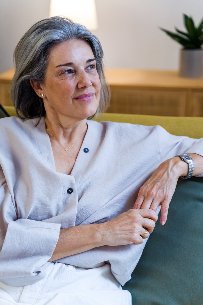 Mature white woman relaxed on sofa in living room