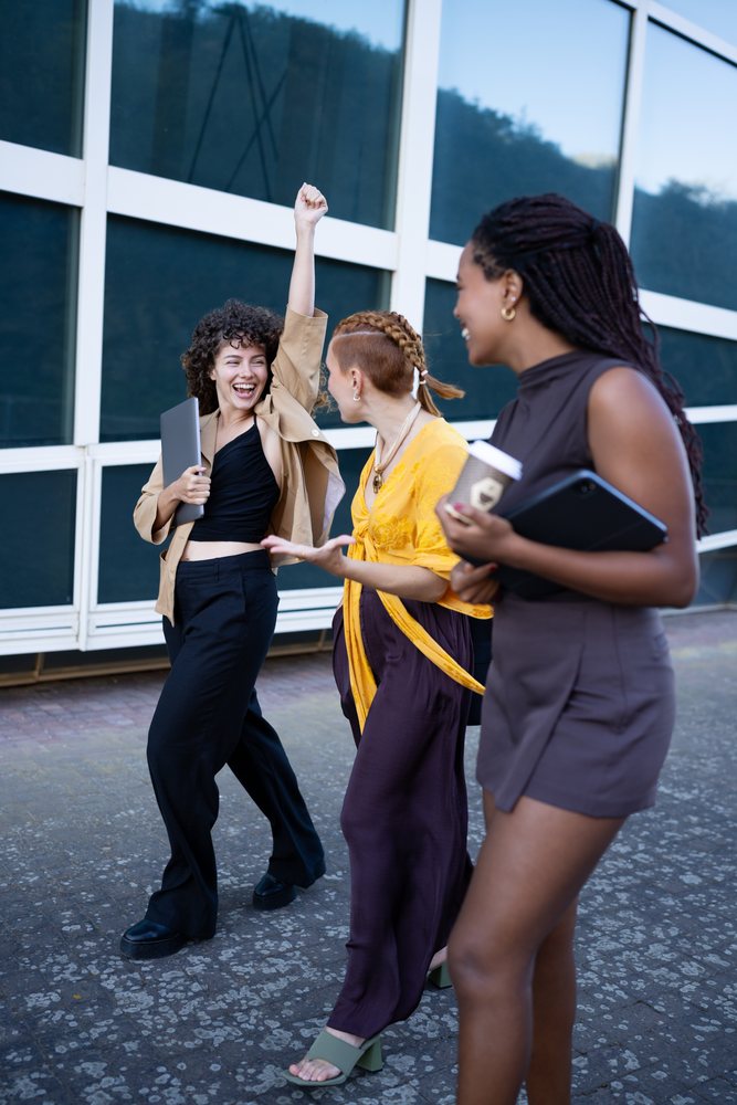 African American and white women celebrating and walking together