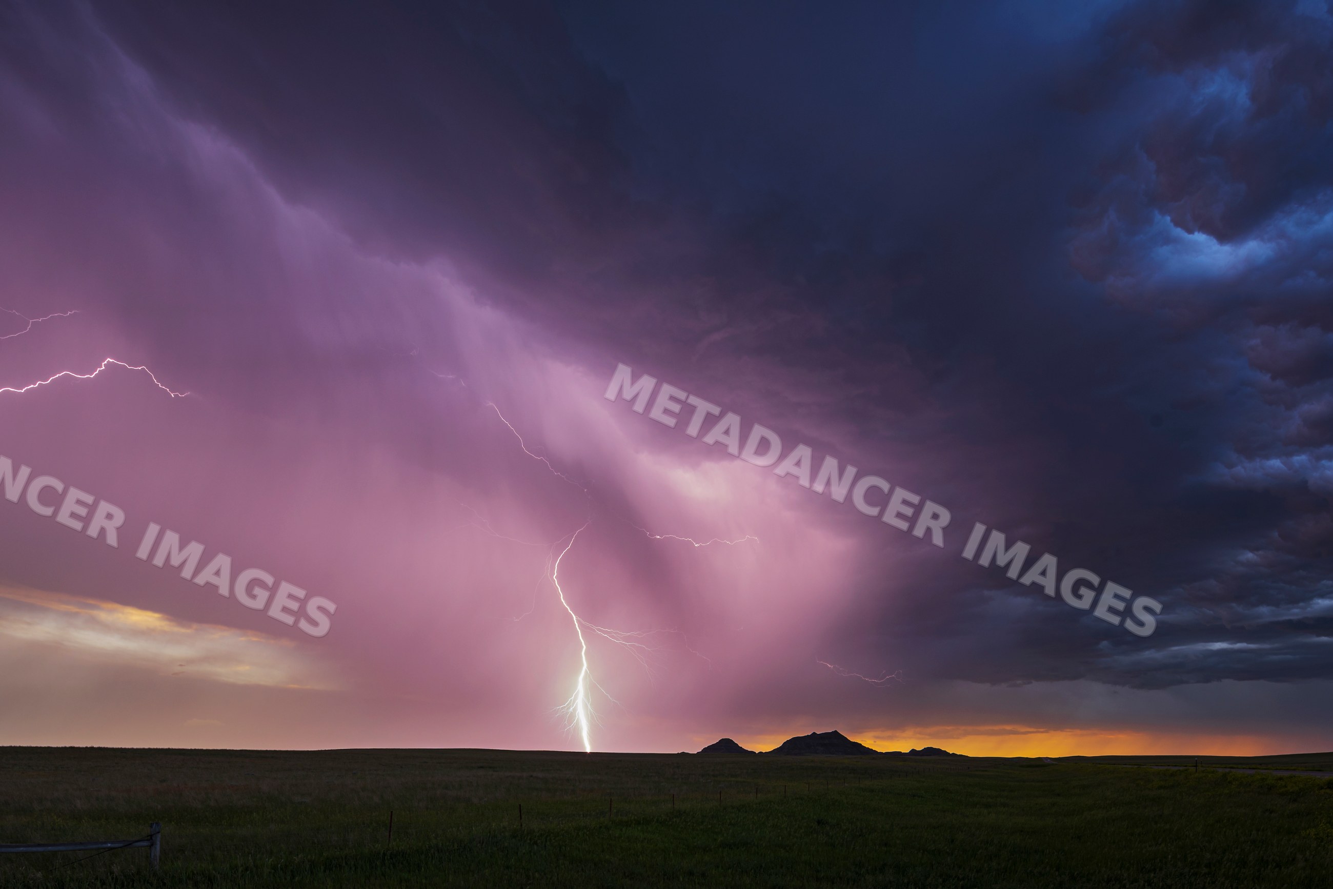 Lightning strike over open plains at sunset in redig, south dakota