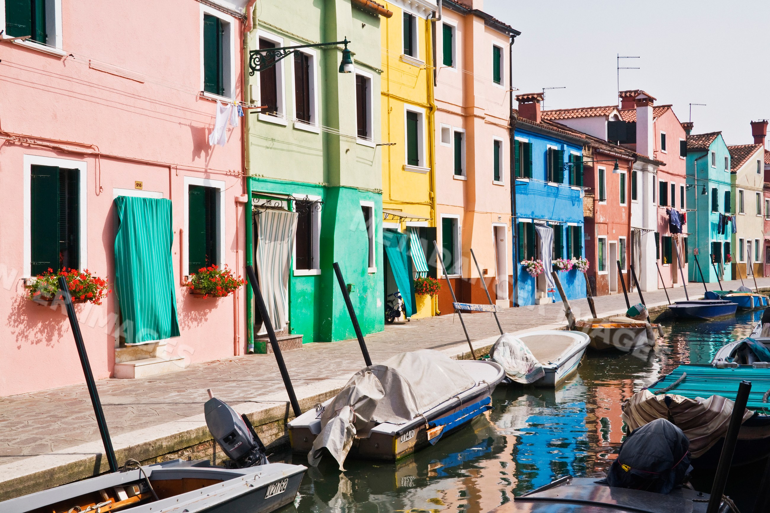 Colorful houses along canal with boats in venice veneto italy