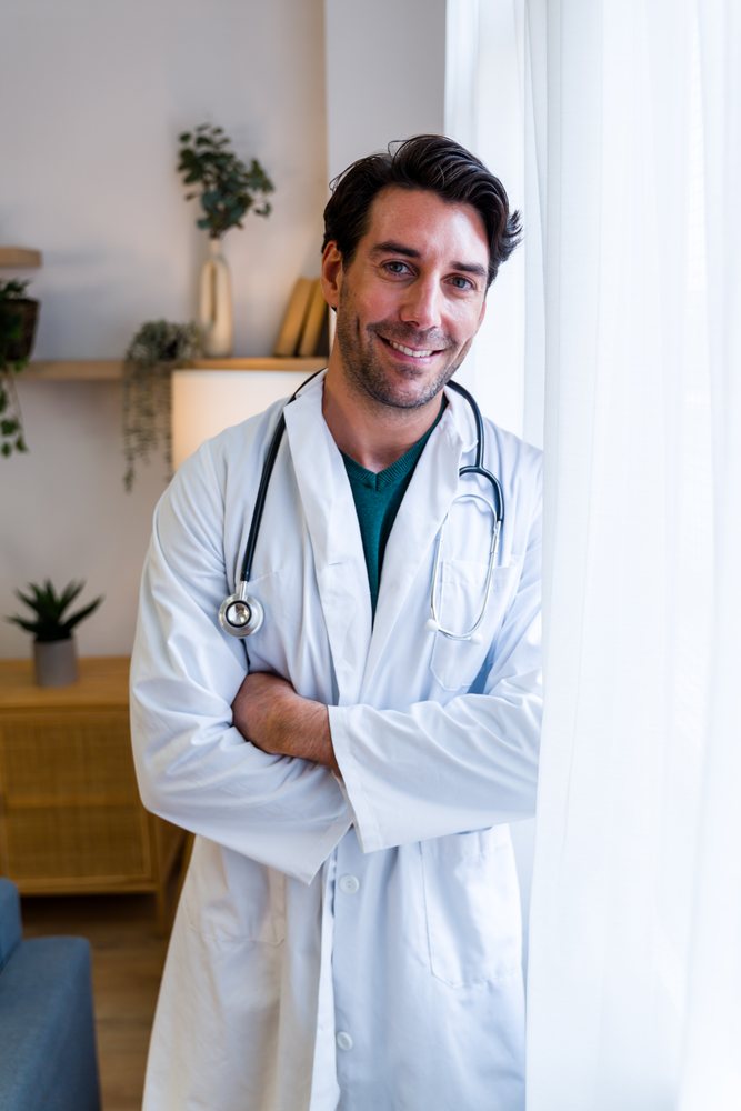 Male doctor smiling confidently in a modern medical office