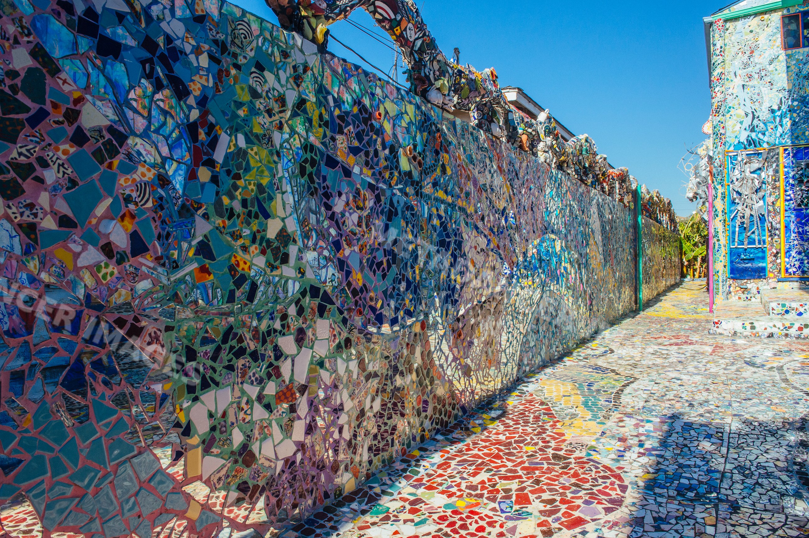 Colorful mosaic tile art decorating outdoor walls and pathway