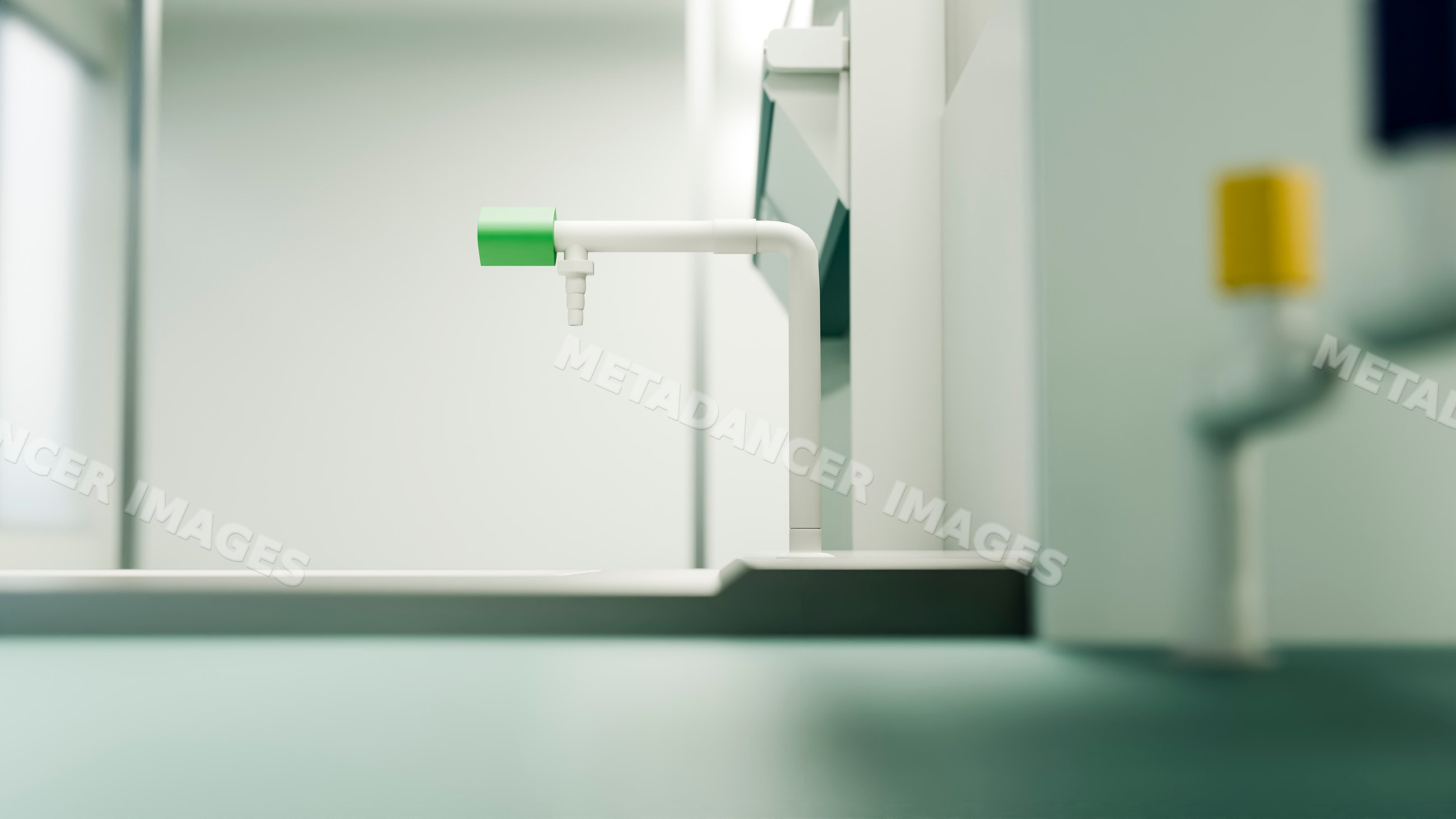 Laboratory faucet with green handle above clean sink workspace