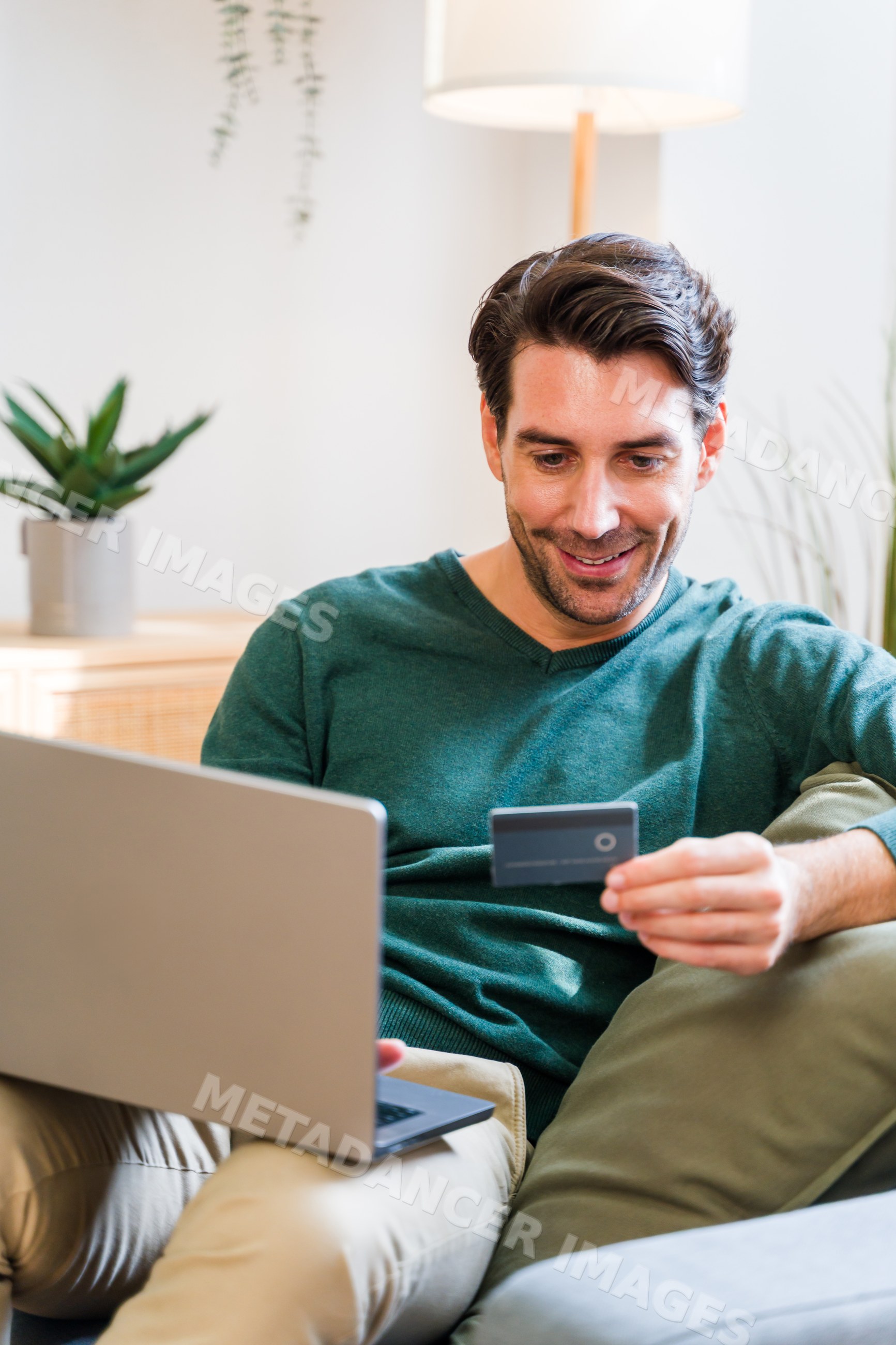 White man using laptop and credit card for online shopping