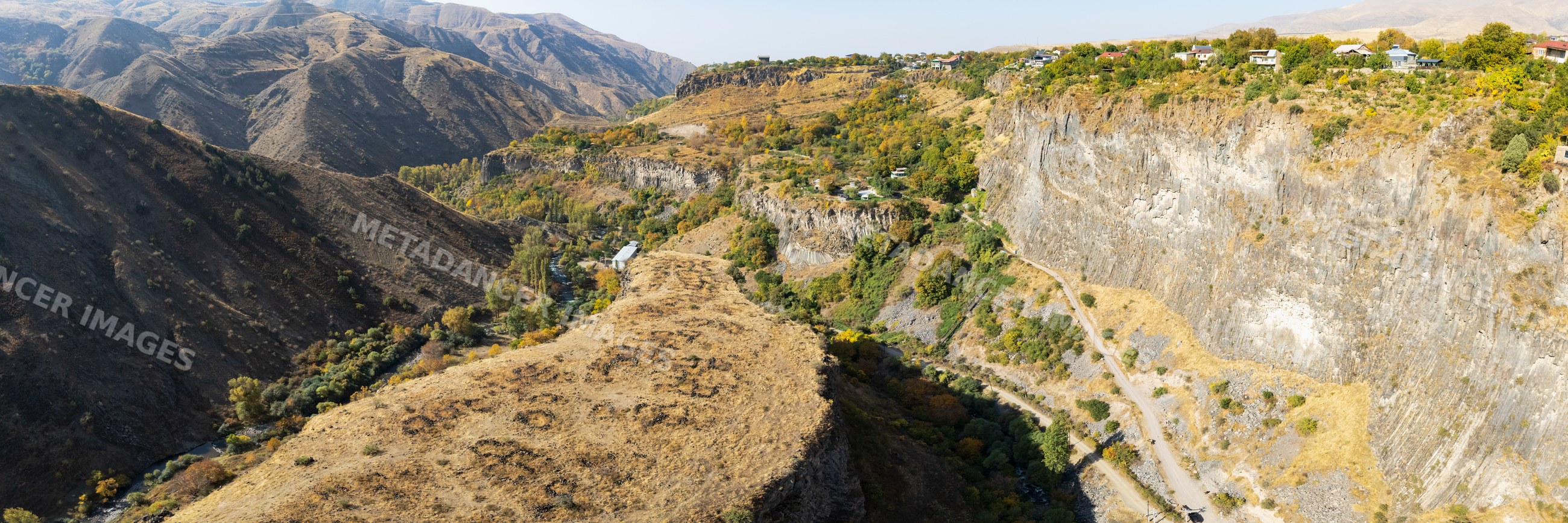 Panoramic mountainous valley with cliffs and river
