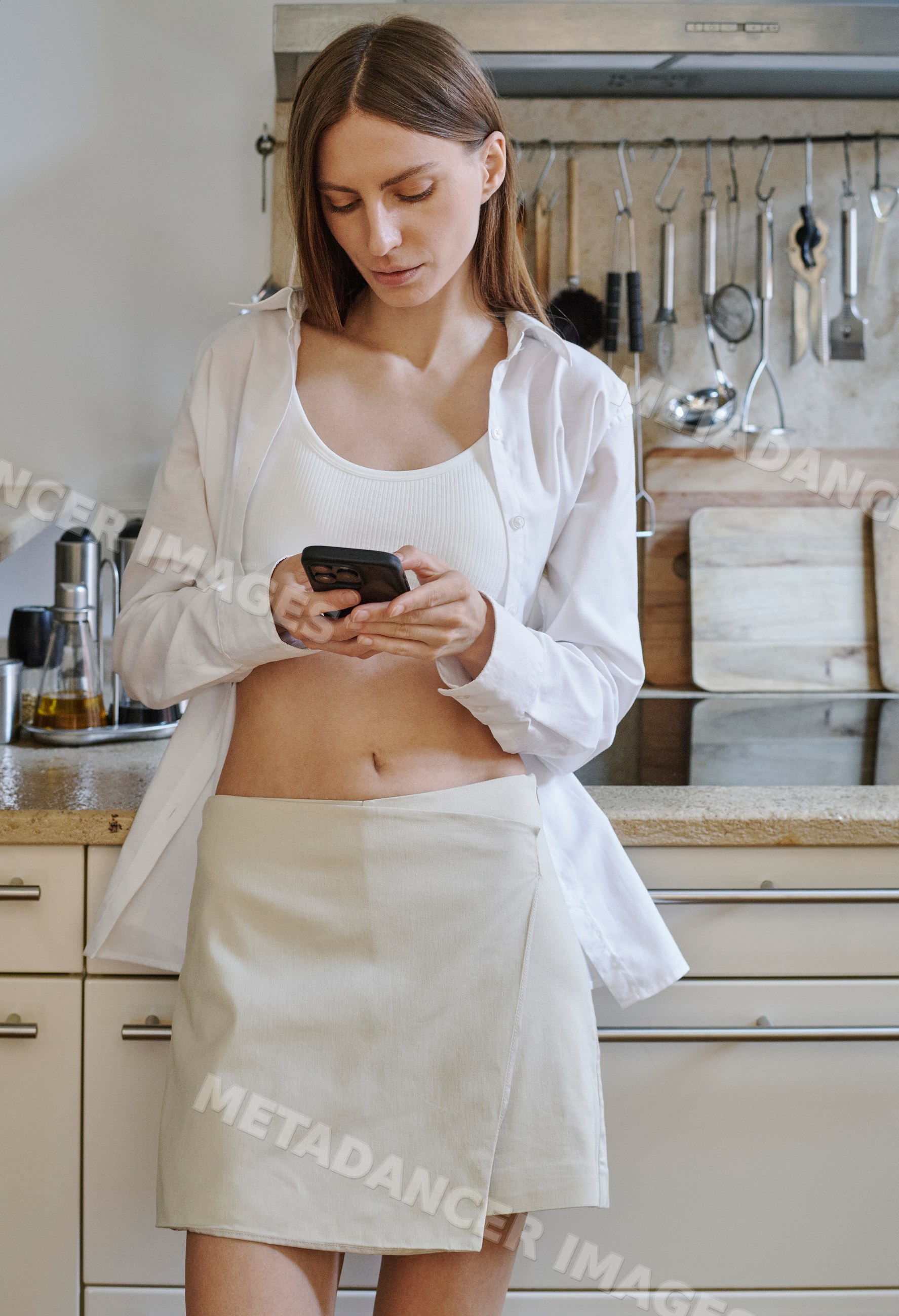 A white woman texts on her phone