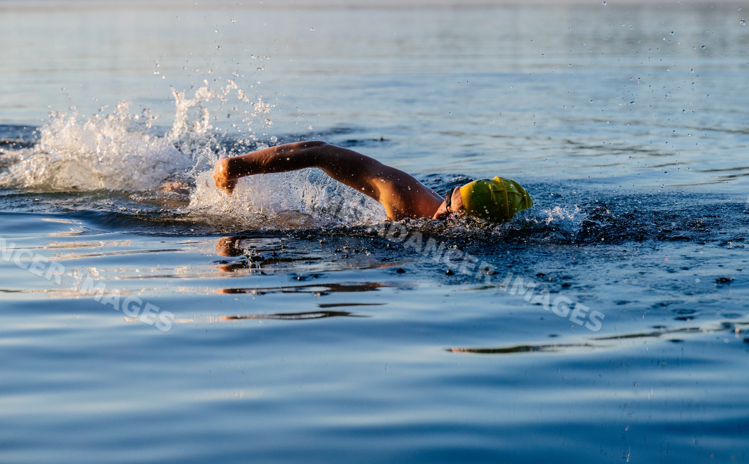White swimmer performing freestyle stroke in open water in USA