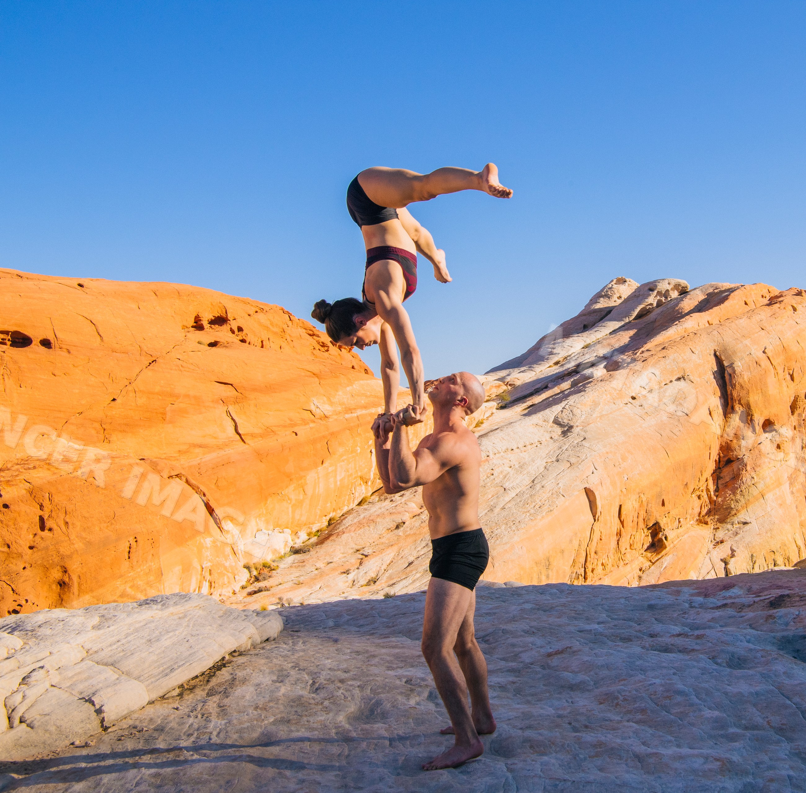 White man balancing woman