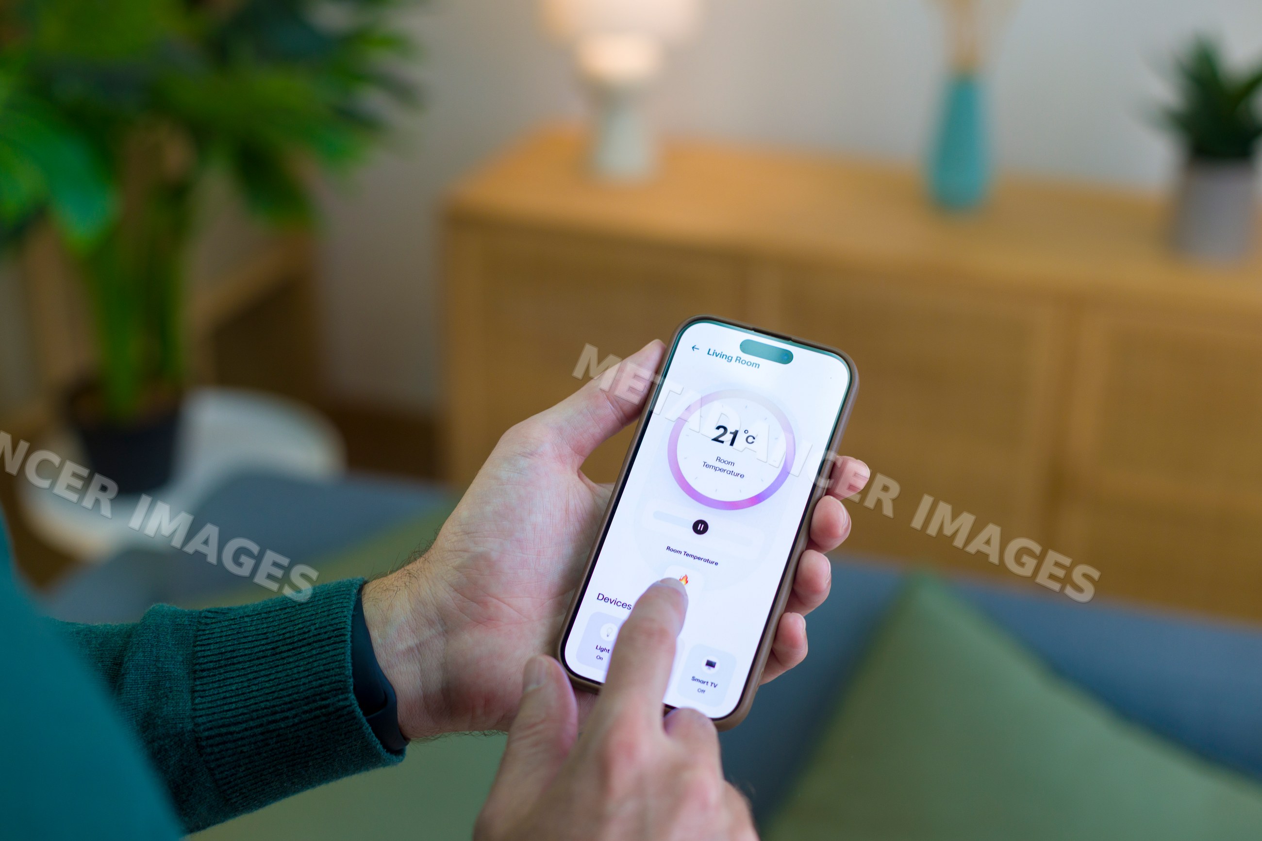 White person adjusting room temperature on smartphone app