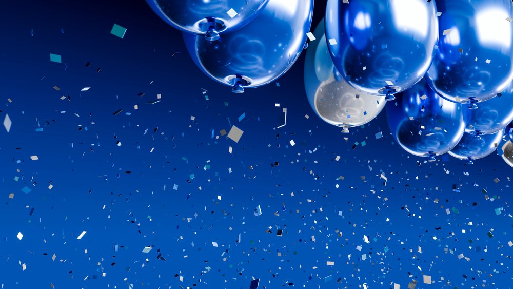 Blue and silver balloons with confetti for festive celebration