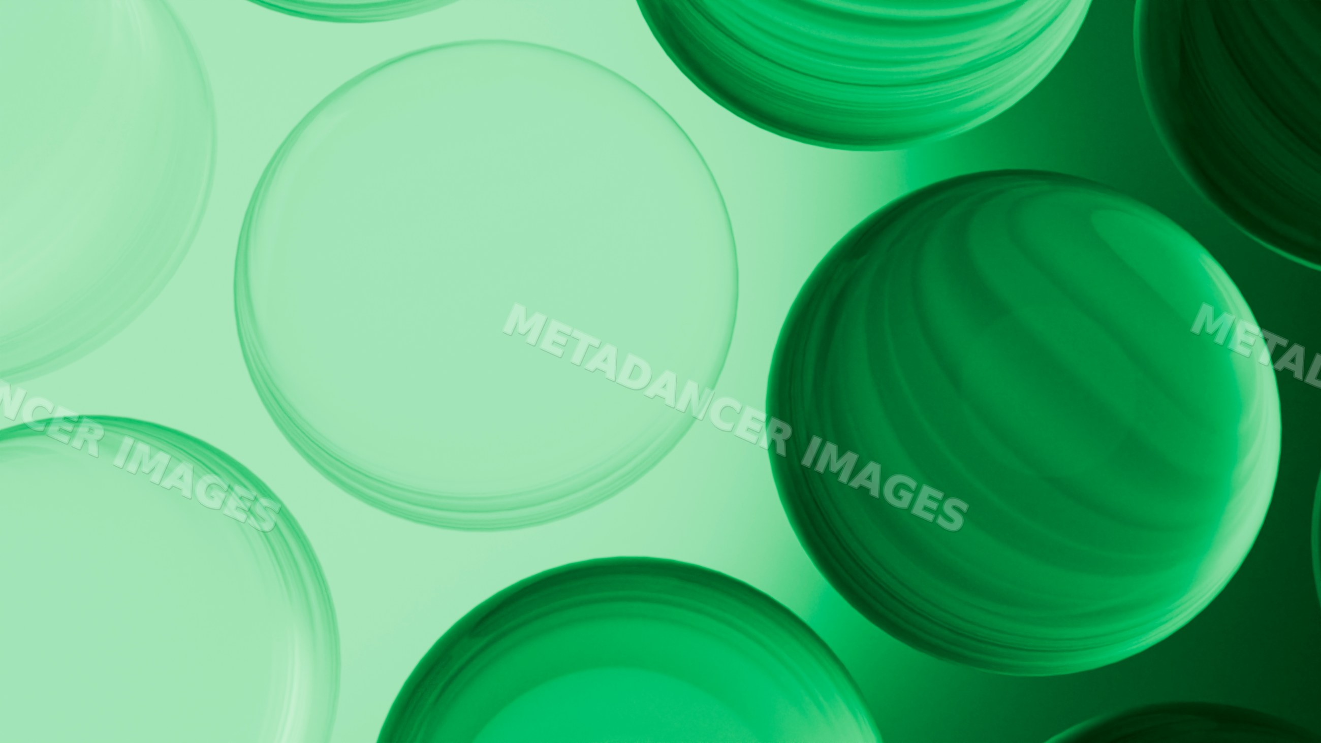 Abstract digital illustration of overlapping green transparent spheres
