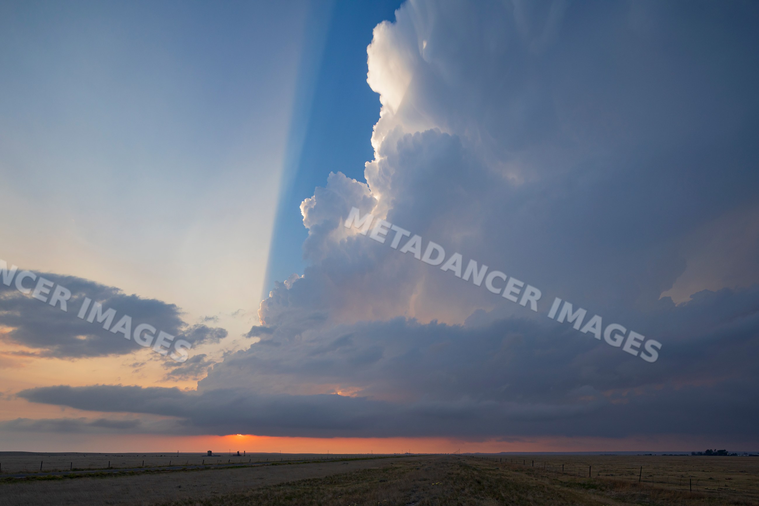Storm cloud and crepuscular rays at sunset over grover